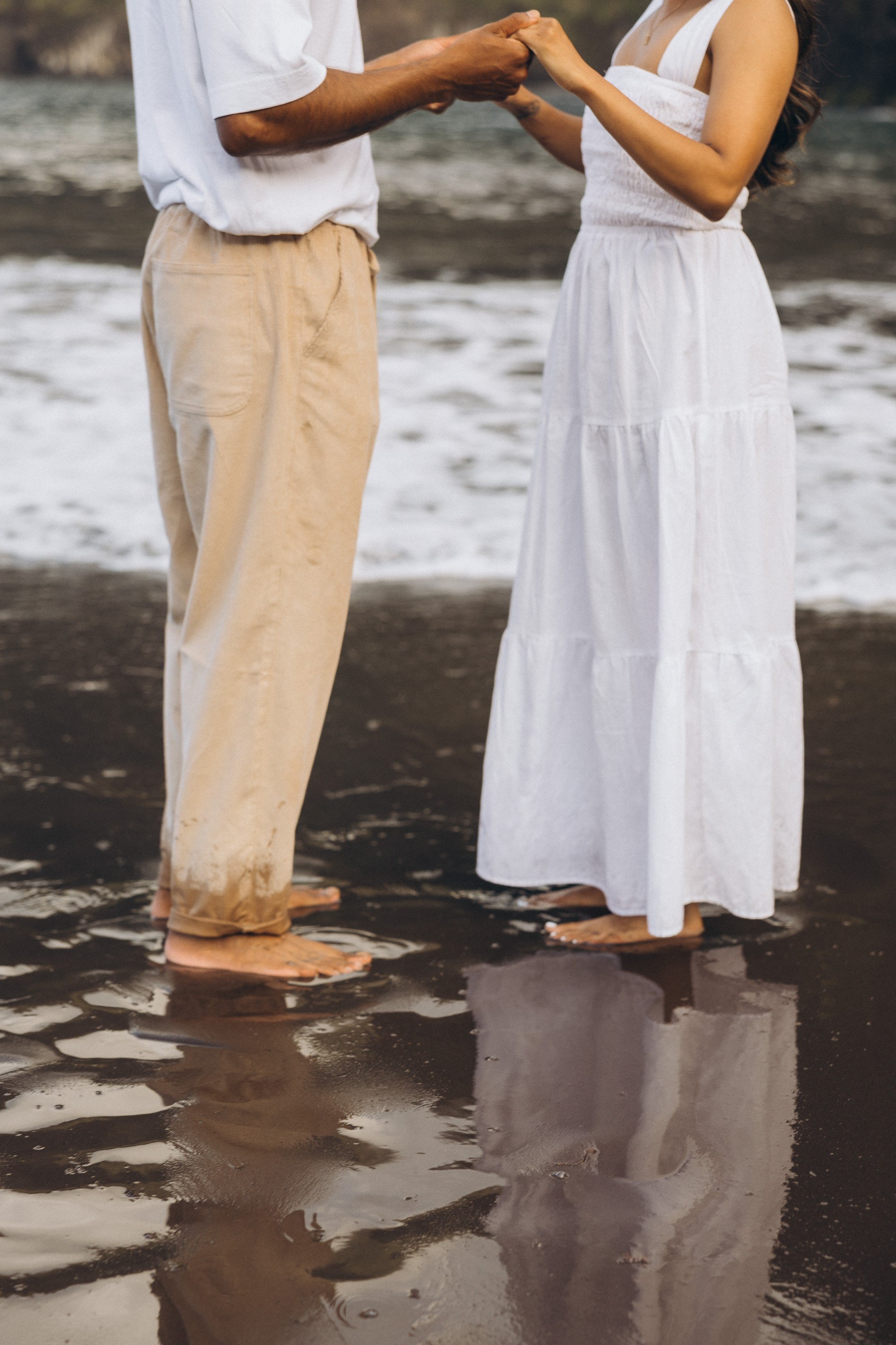 Romantic proposal on Seixal Beach, Madeira — black sand and ocean waves.