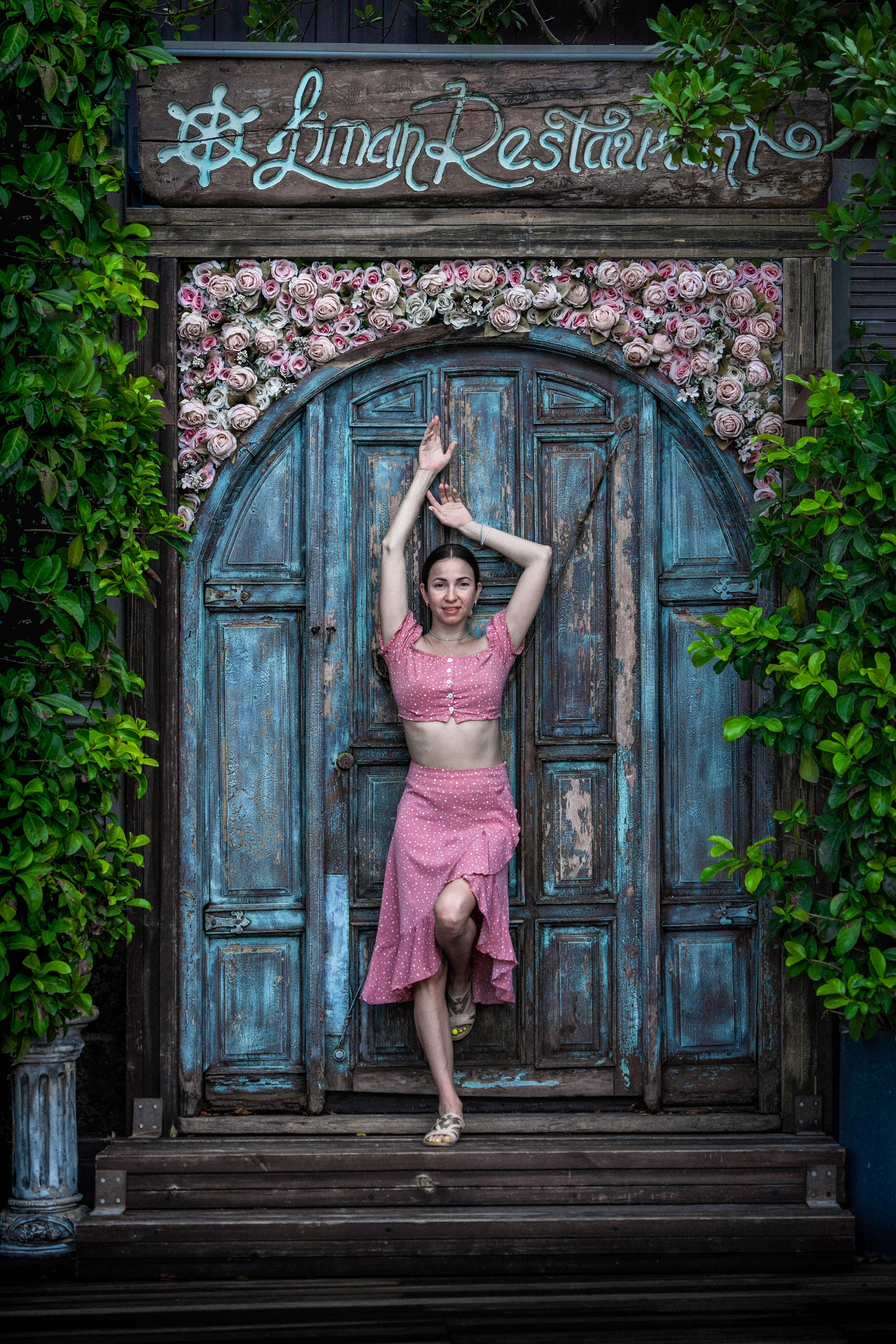 Female portrait framed by architectural arch, creative portrait photography