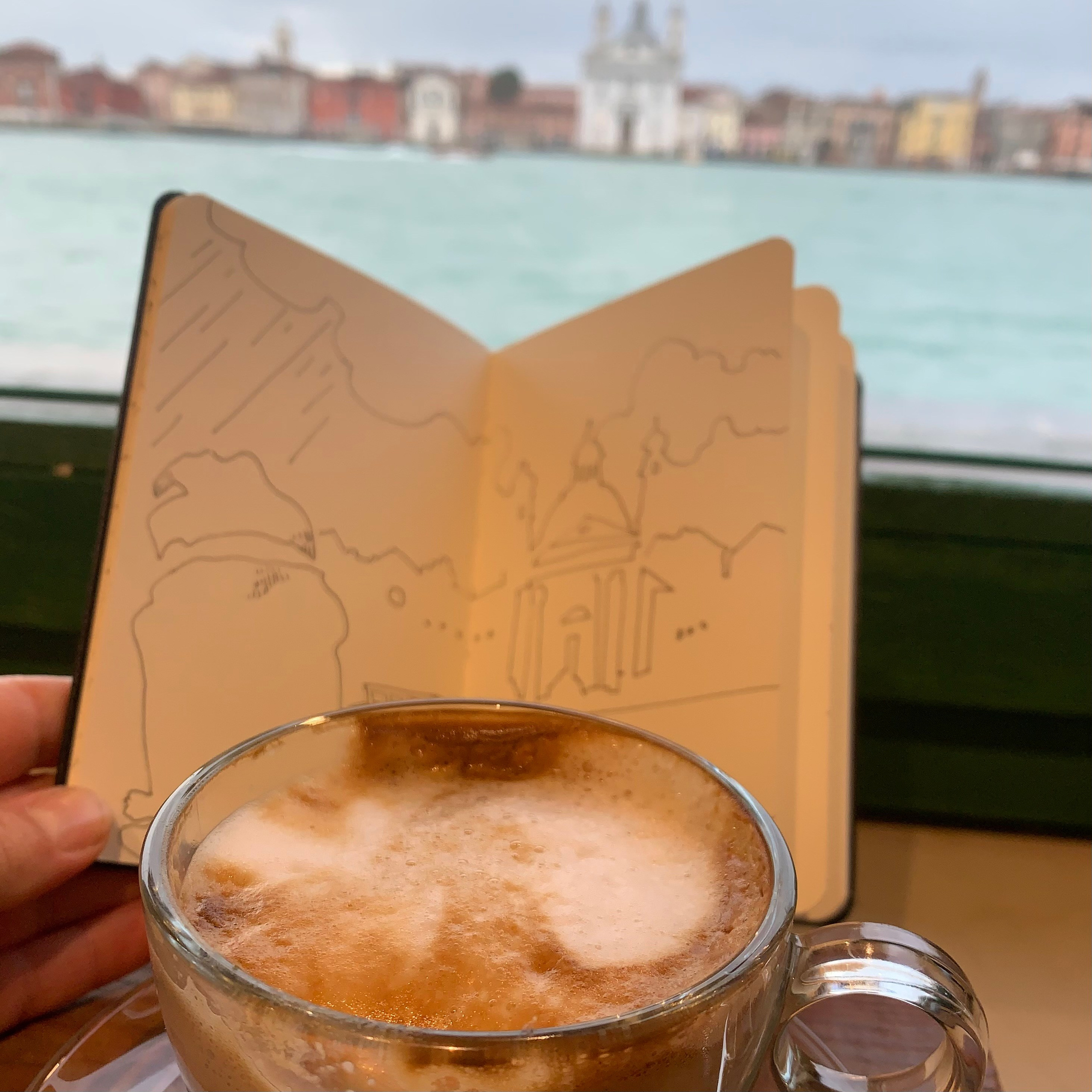 Moleskine notebook with hand-drawn sketches made in Venice, reflecting Nadia Kuprina’s daily drawing practice rooted in observation and visual research. A photo of a cappuccino with drawing.