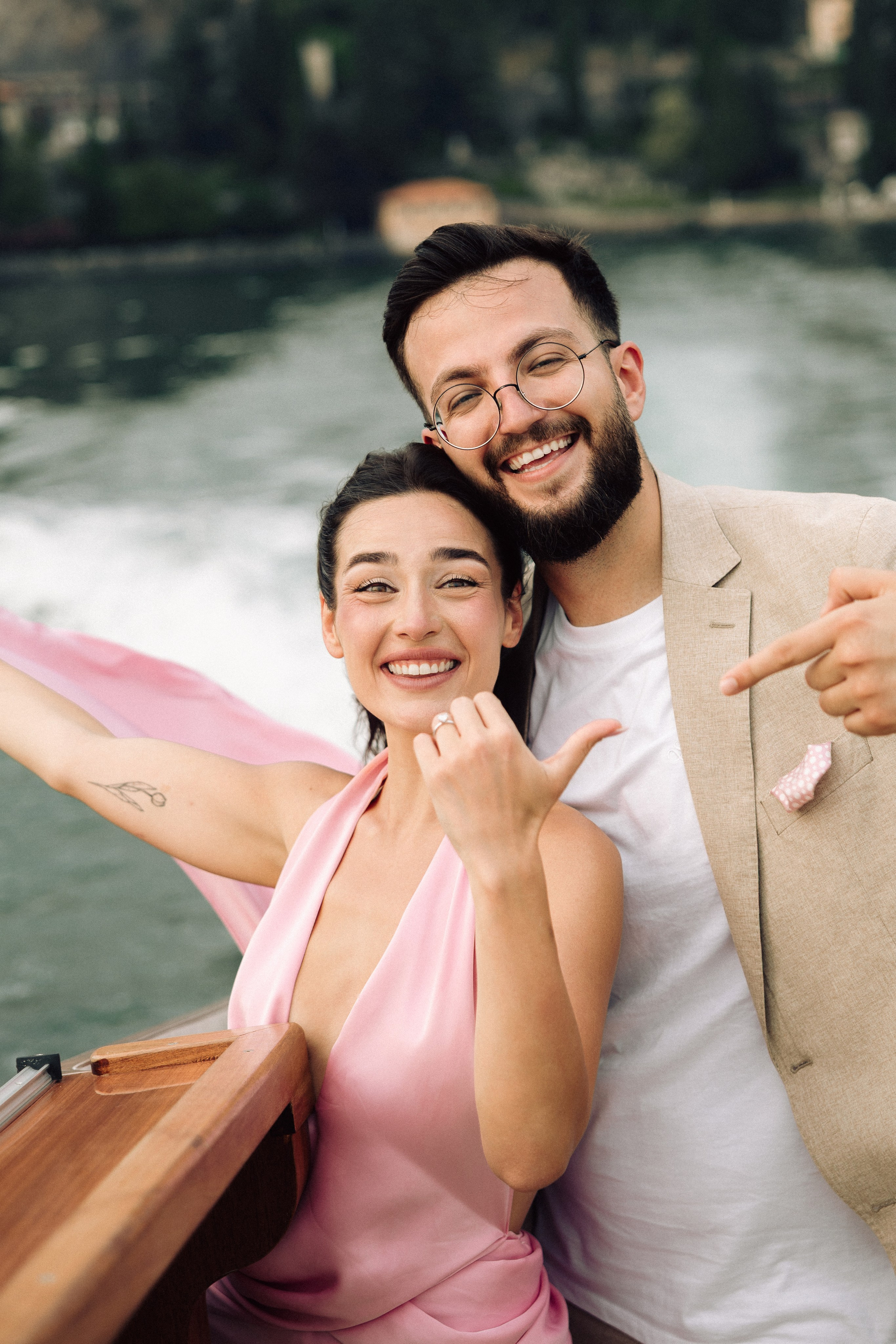 Bride-to-be standing on a boat on Lake Como during her surprise marriage proposal