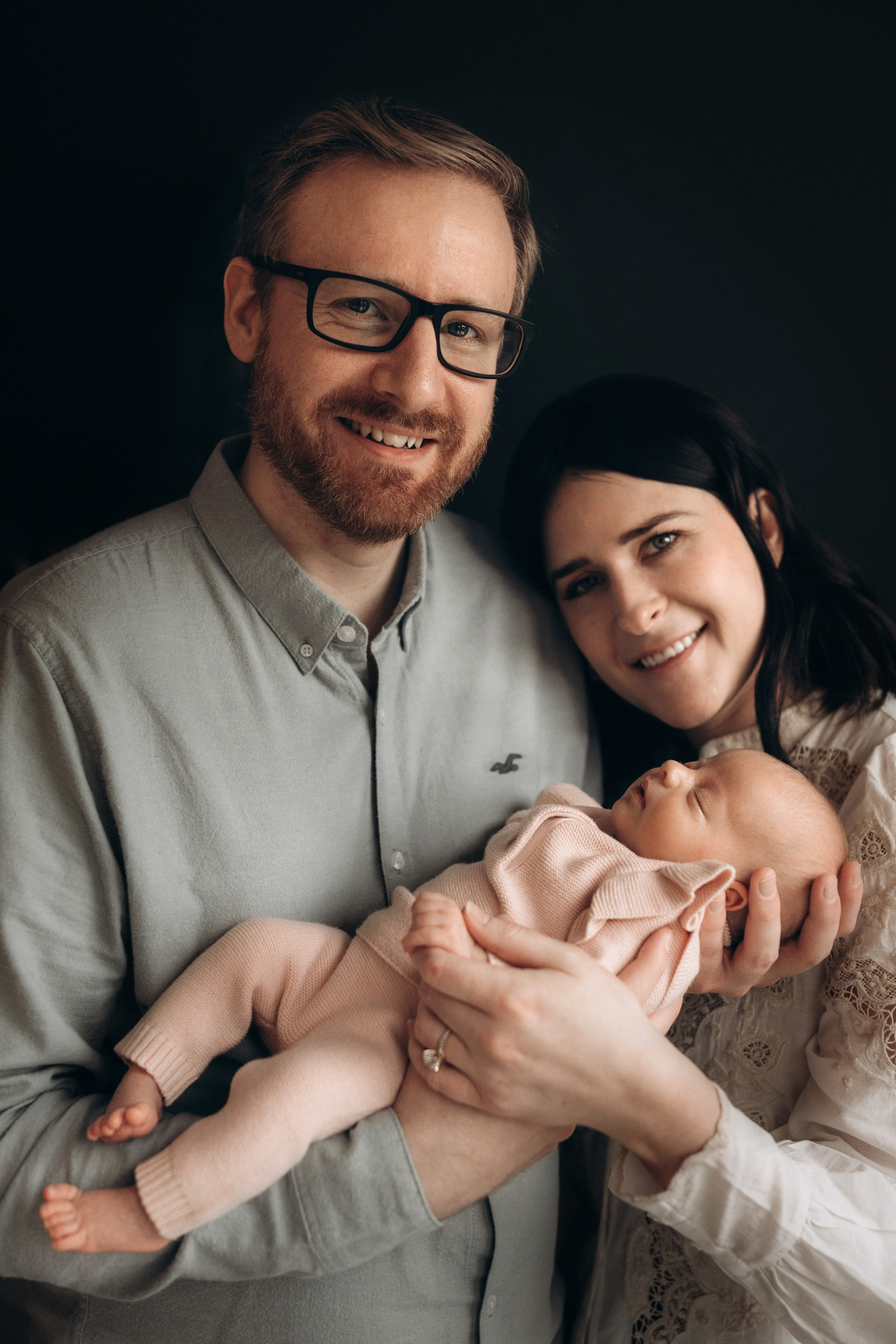 parents hold the baby