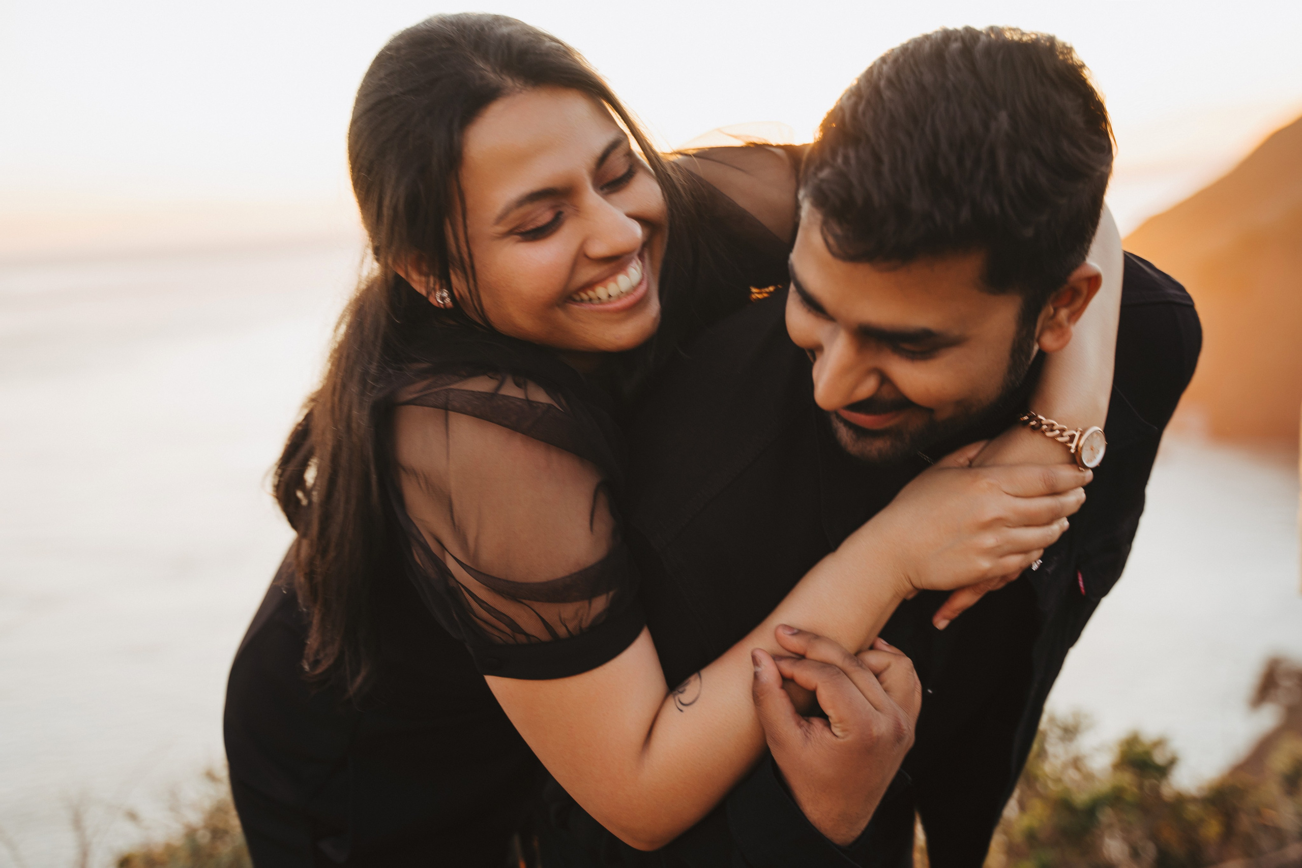 Proposal.  Overlooking the golden San Franisco Bridge sunset with a couple. Photographer Video. 