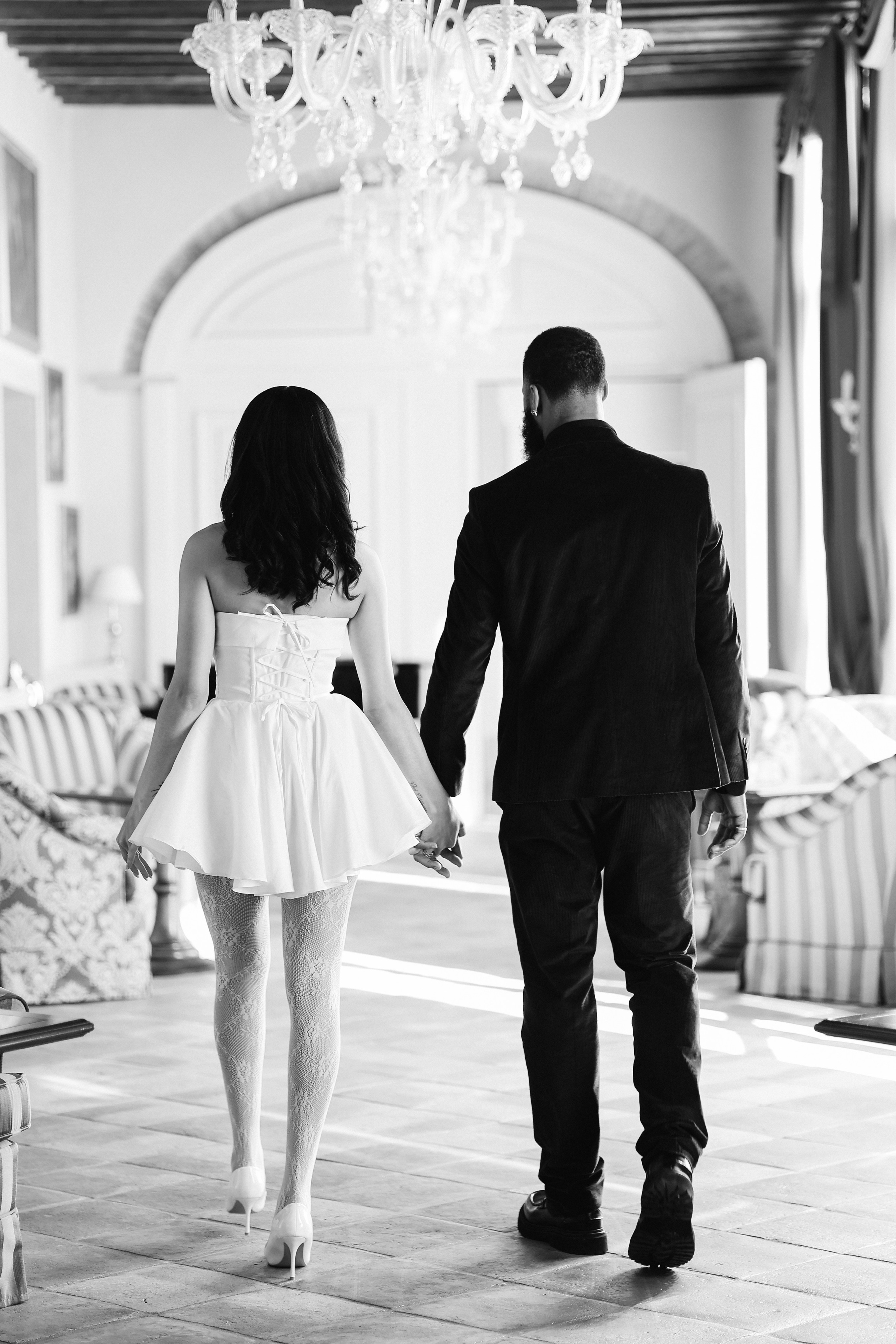 Newlywed couple walking through a beautiful Italian villa