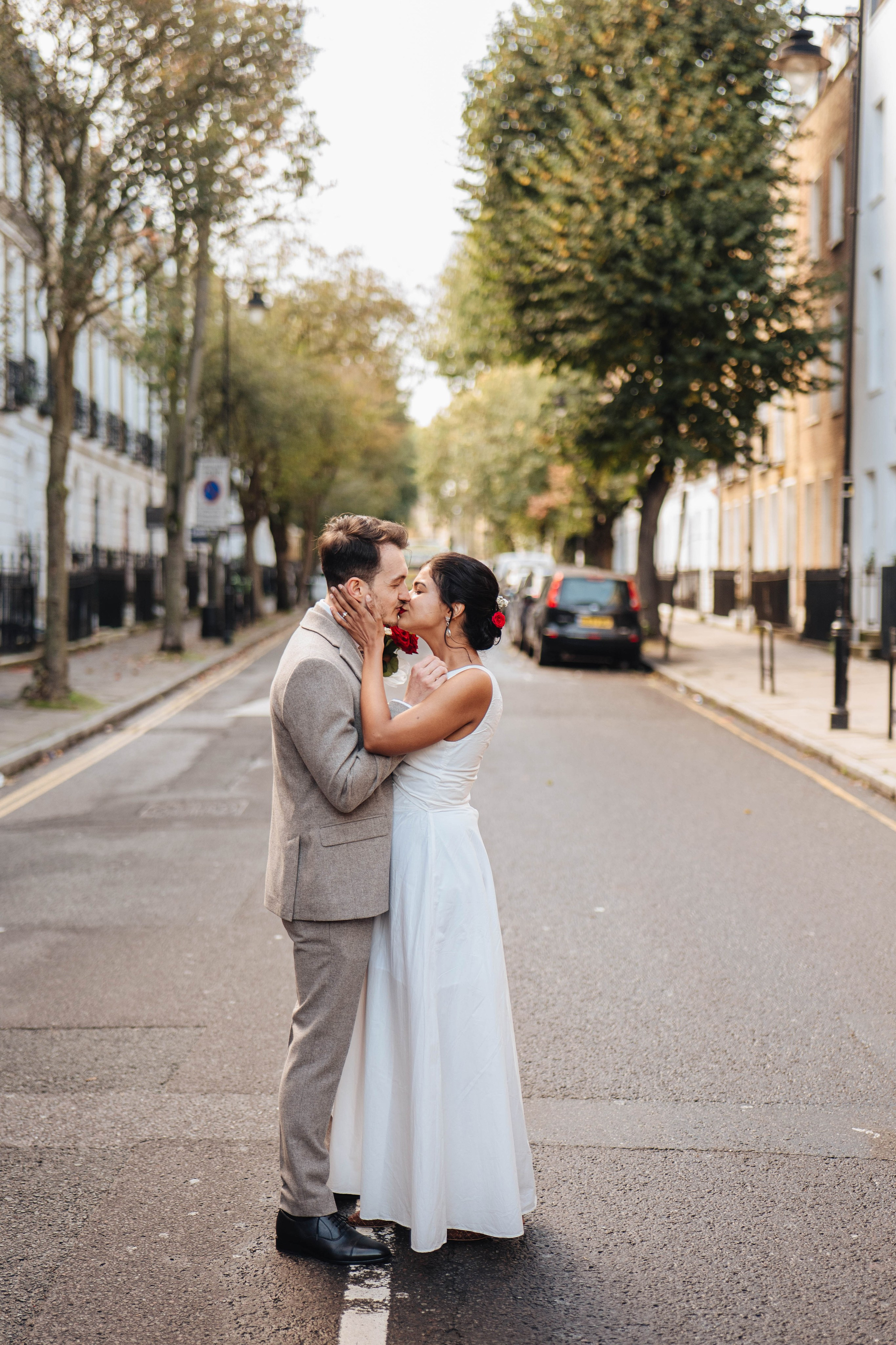 Wedding couple on the road crossing in Islington near Islington town hall