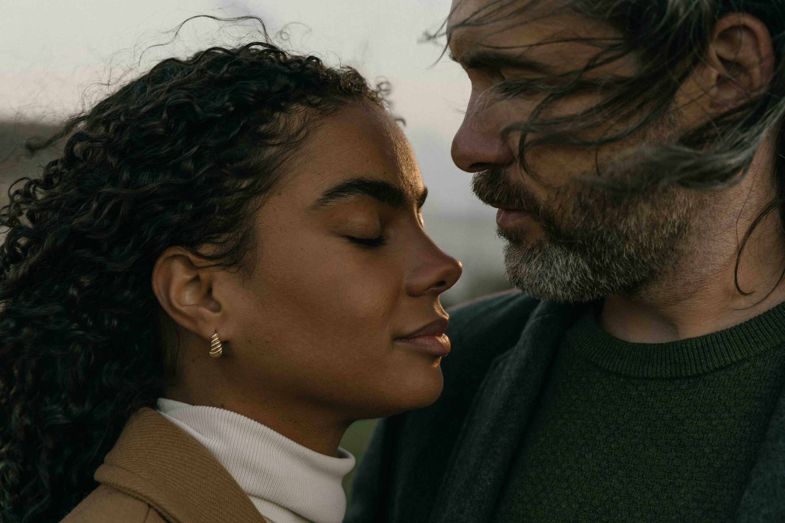 romantic couple hugging windy beach seven sisters uk photoshoot