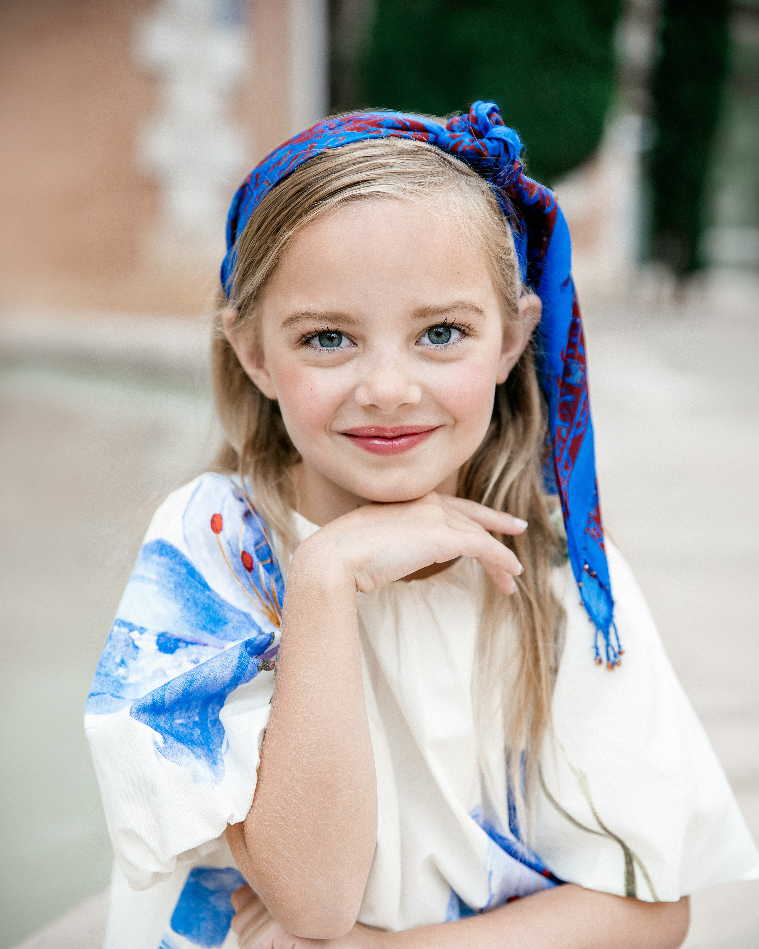 Children’s portrait photoshoot in Valencia, Spain featuring a smiling young girl in a colorful headband. Natural lifestyle portrait ideal for children’s photography, kids photoshoots, family portraits and professional photography in Valencia and Spain.