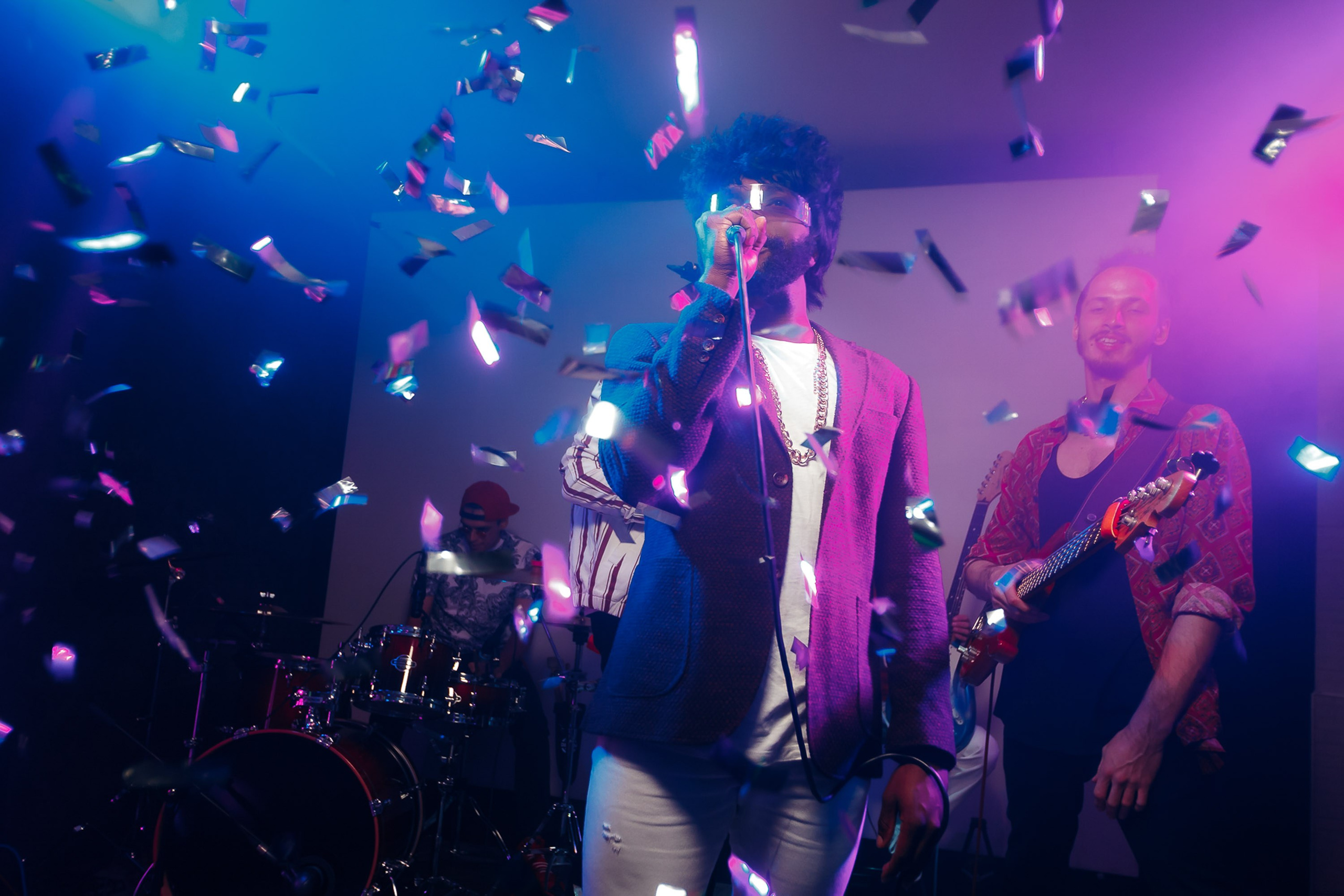 Crowd dancing with confetti, vibrant party atmosphere
