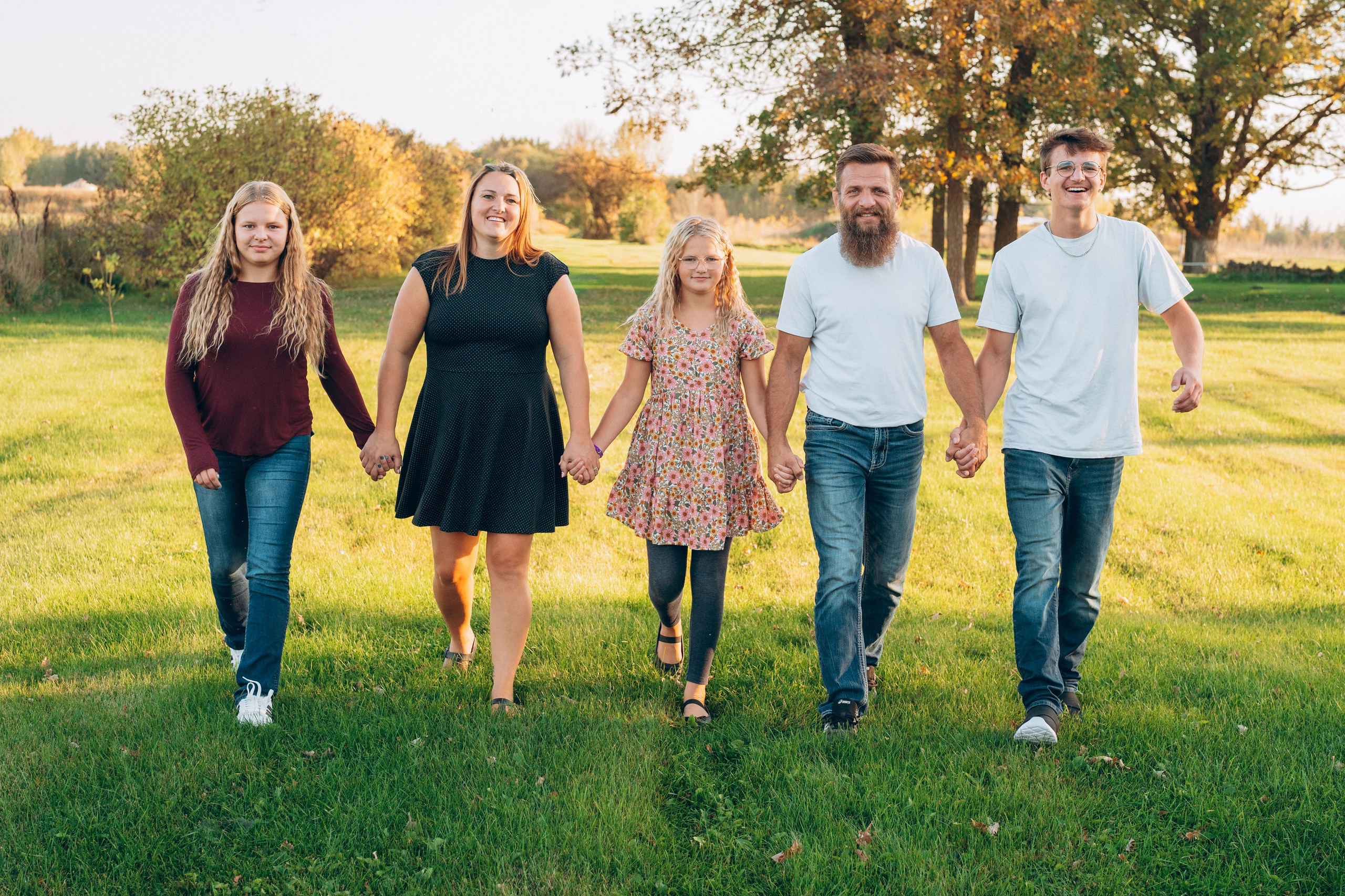 Family walking hand in hand outdoors