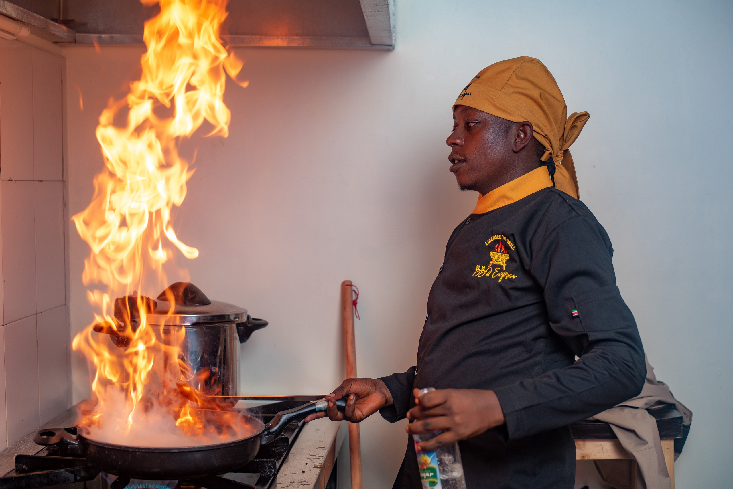 A chef flambes a dish at a Nairobi restaurant 
