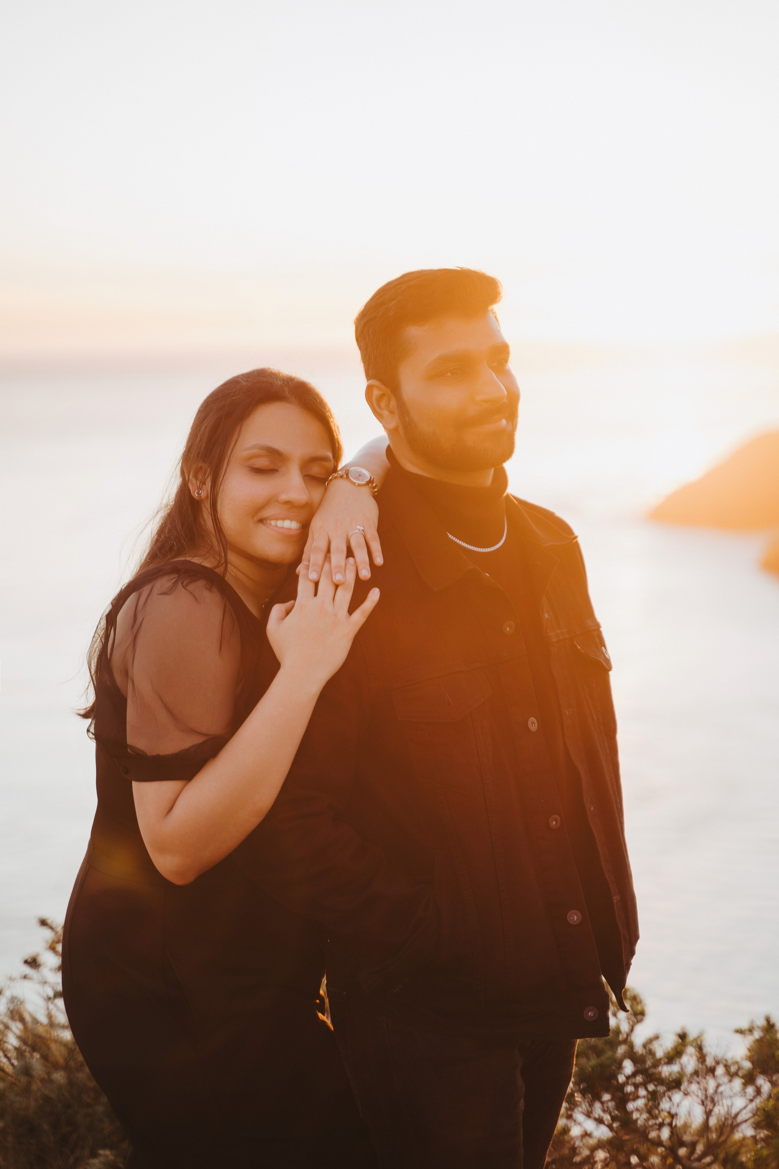 Proposal.  Overlooking the golden San Franisco Bridge sunset with a couple. Photographer Video. 