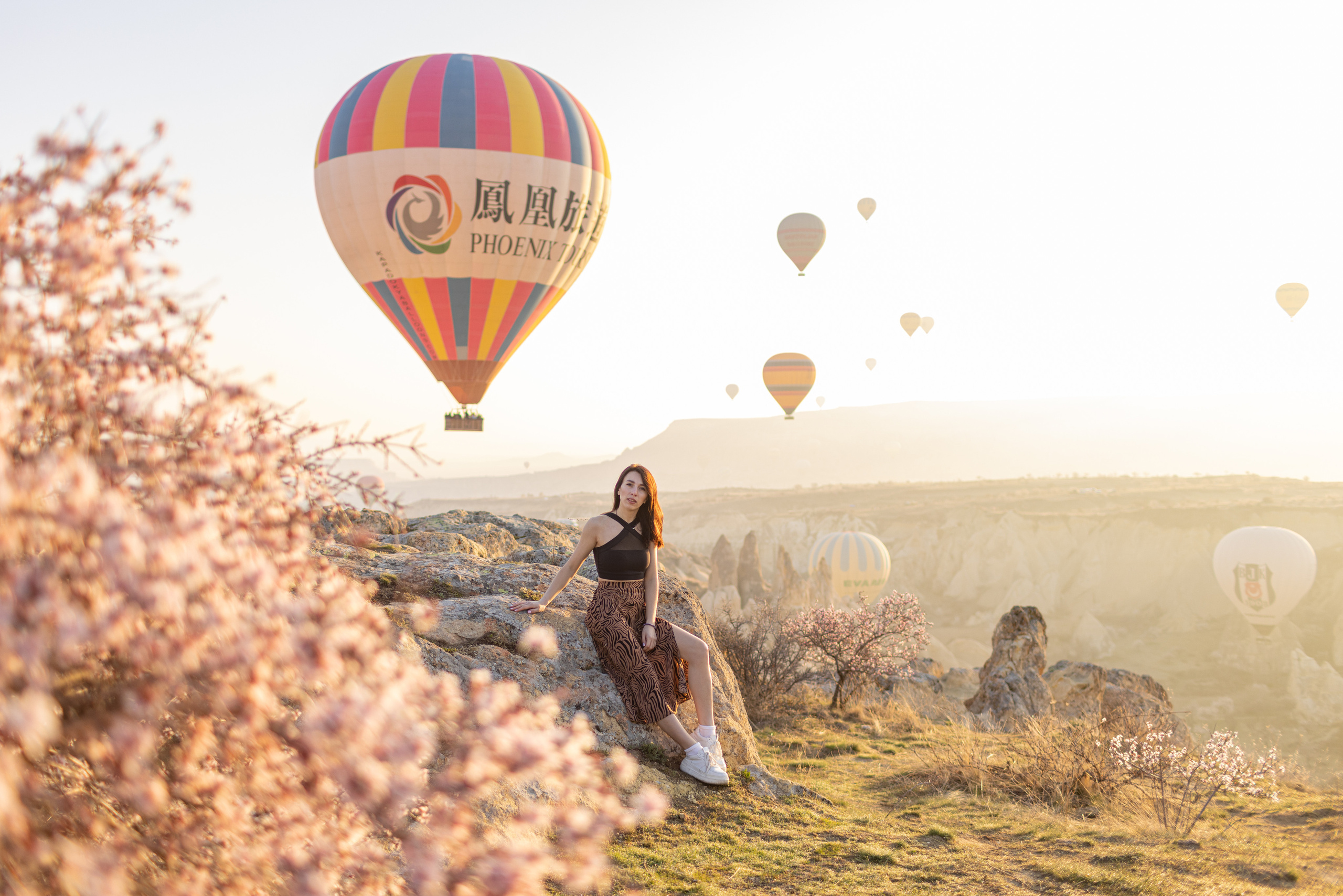 Spring Couple Photoshoot with Hot Air Balloons and Blooming Trees. Julia Ganch I Fashion Wedding Photography I Cappadocia Turkey