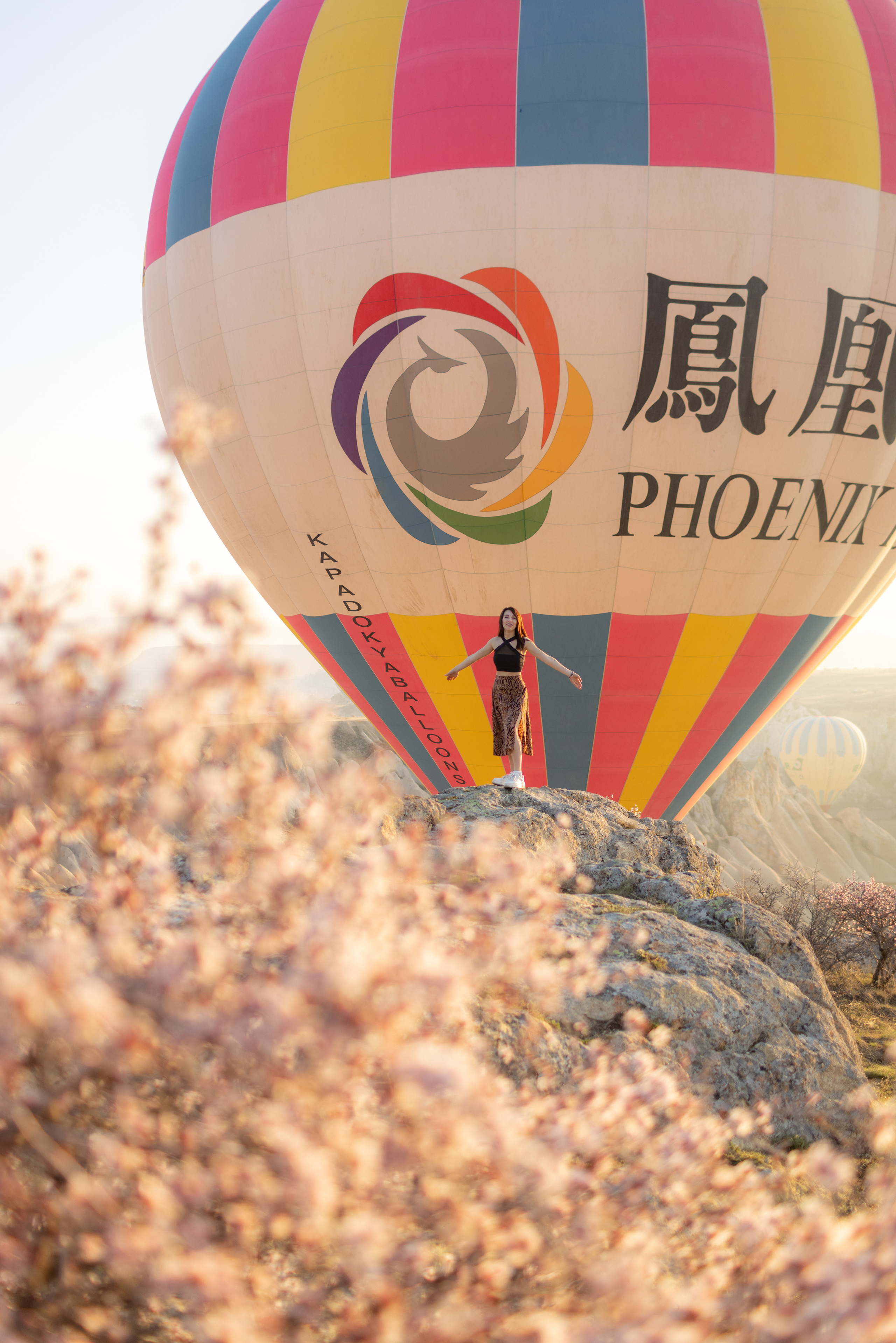 Spring Couple Photoshoot with Hot Air Balloons and Blooming Trees. Julia Ganch I Fashion Wedding Photography I Cappadocia Turkey