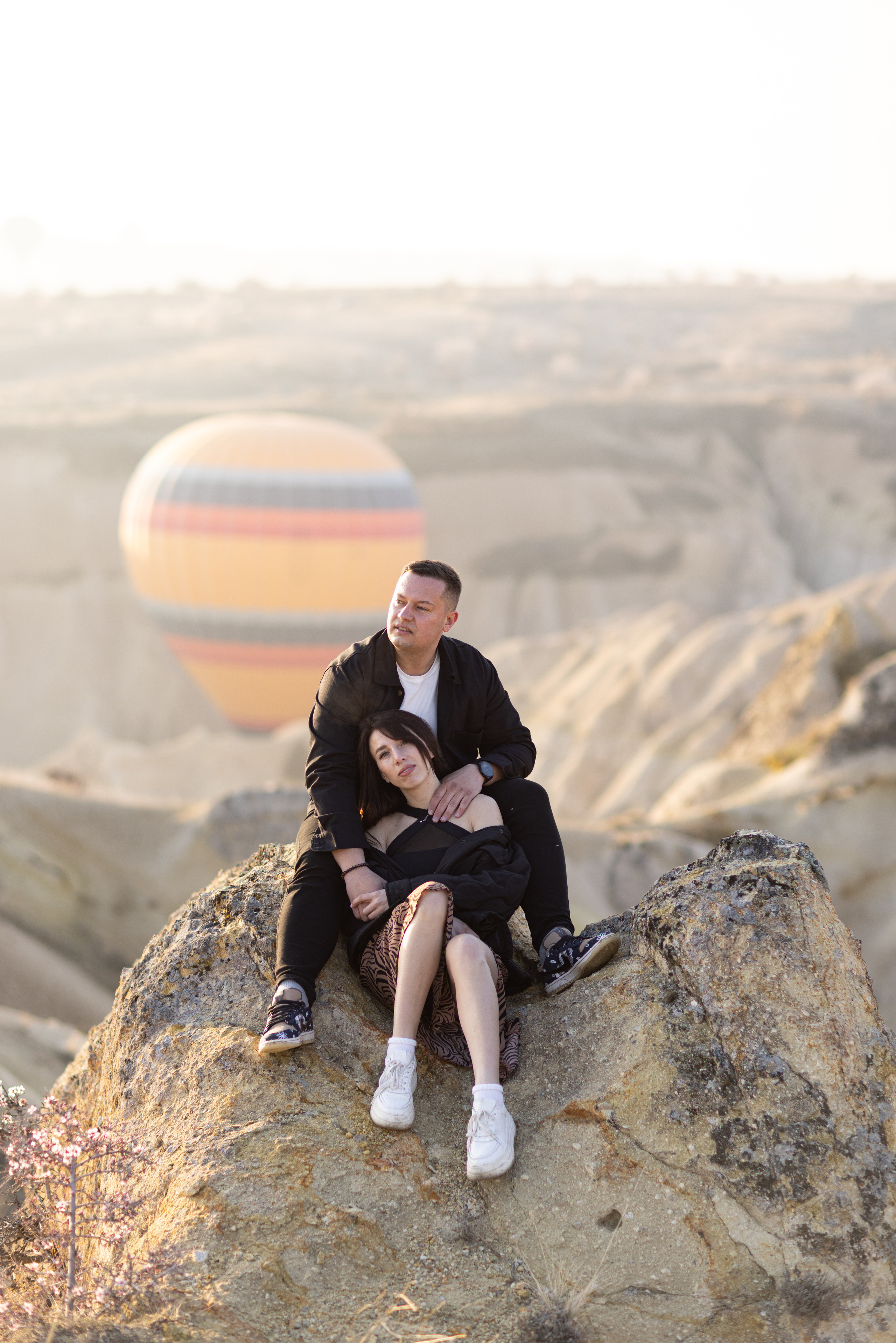 Spring Couple Photoshoot with Hot Air Balloons and Blooming Trees. Julia Ganch I Fashion Wedding Photography I Cappadocia Turkey