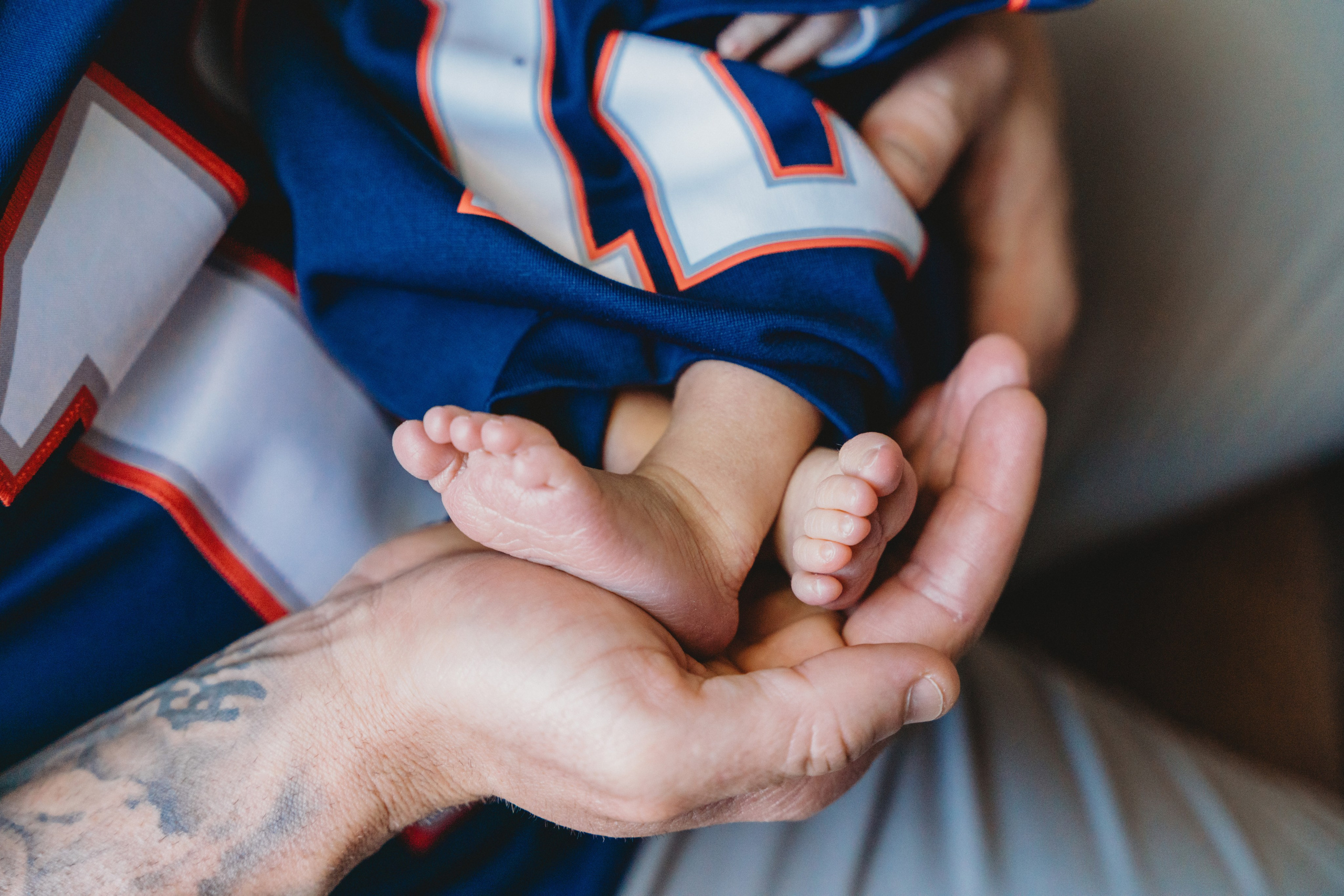 Close up of little feet in fathers hand