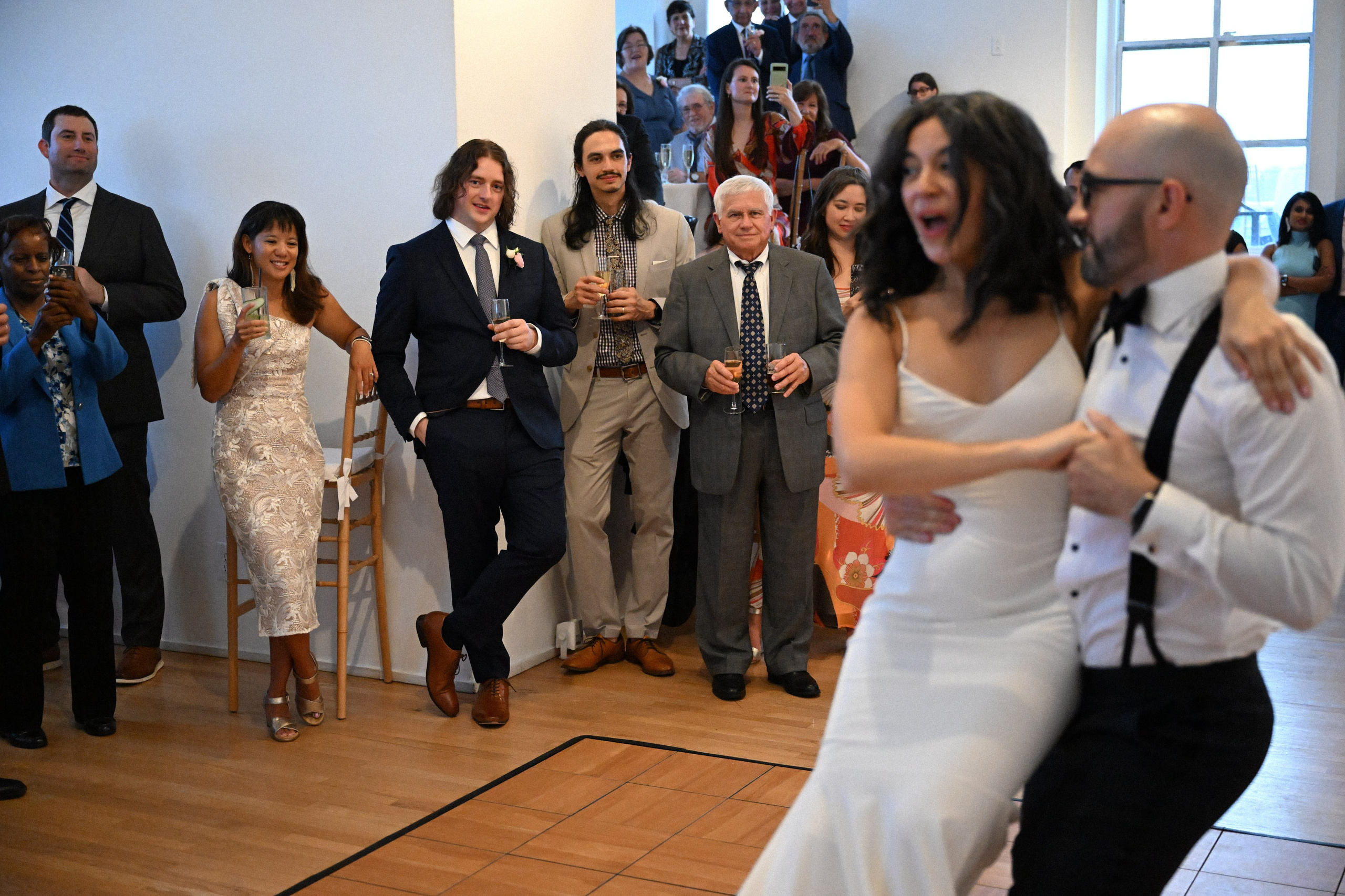 a group of people standing around a woman in a white dress
