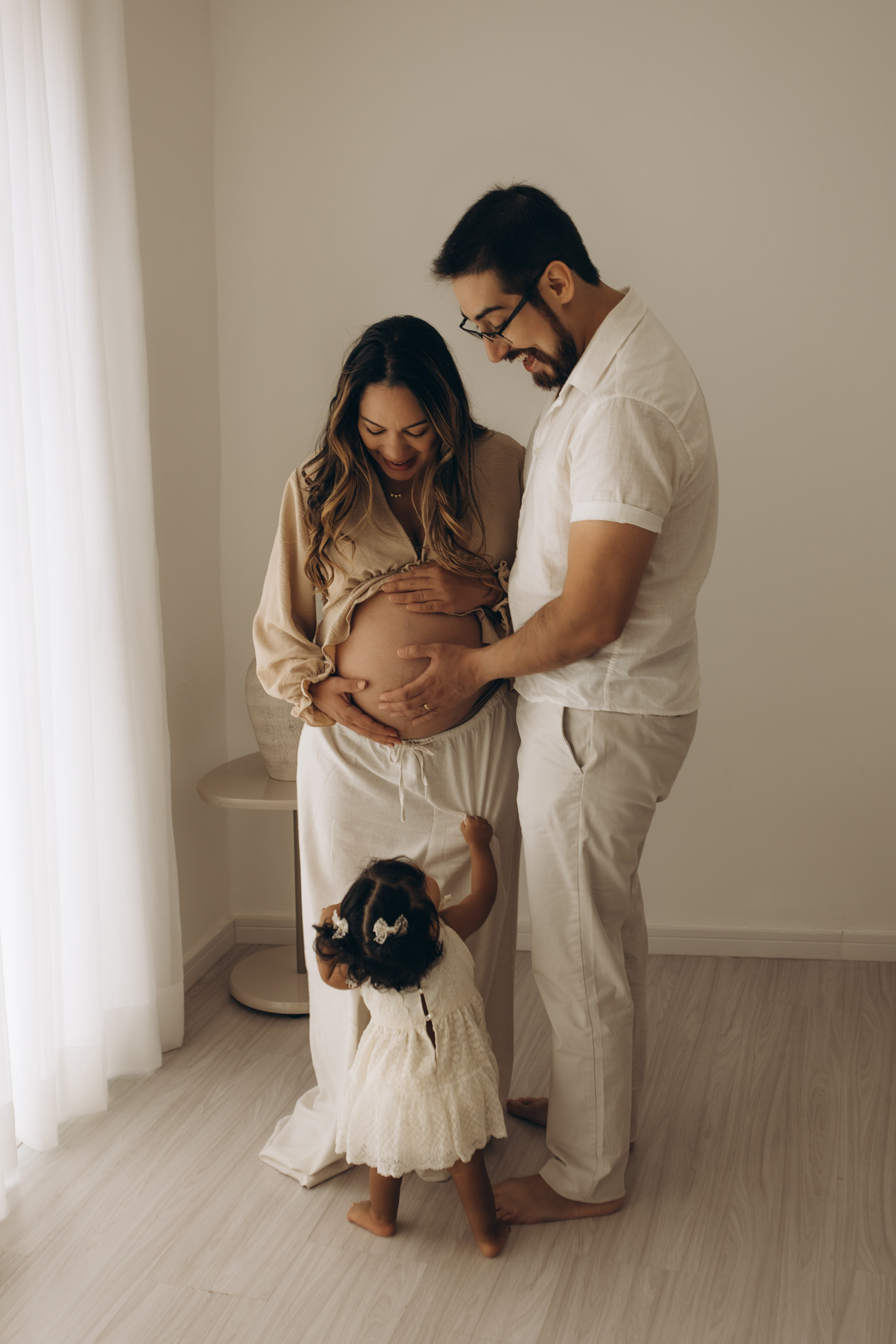 família reunida em ensaio gestante com luz natural em estúdio em Sorocaba