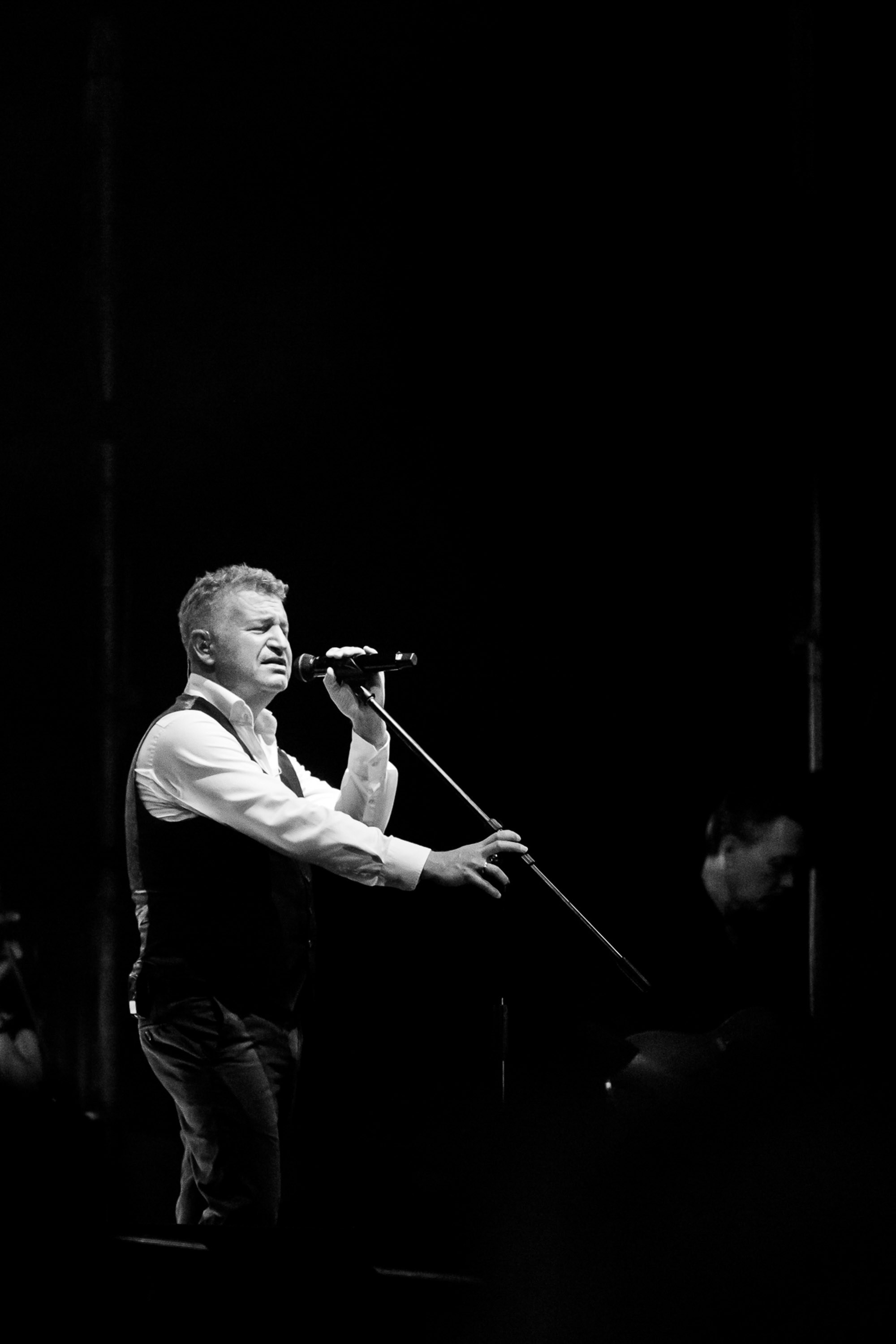 Man singing on stage, black and white artistic shot