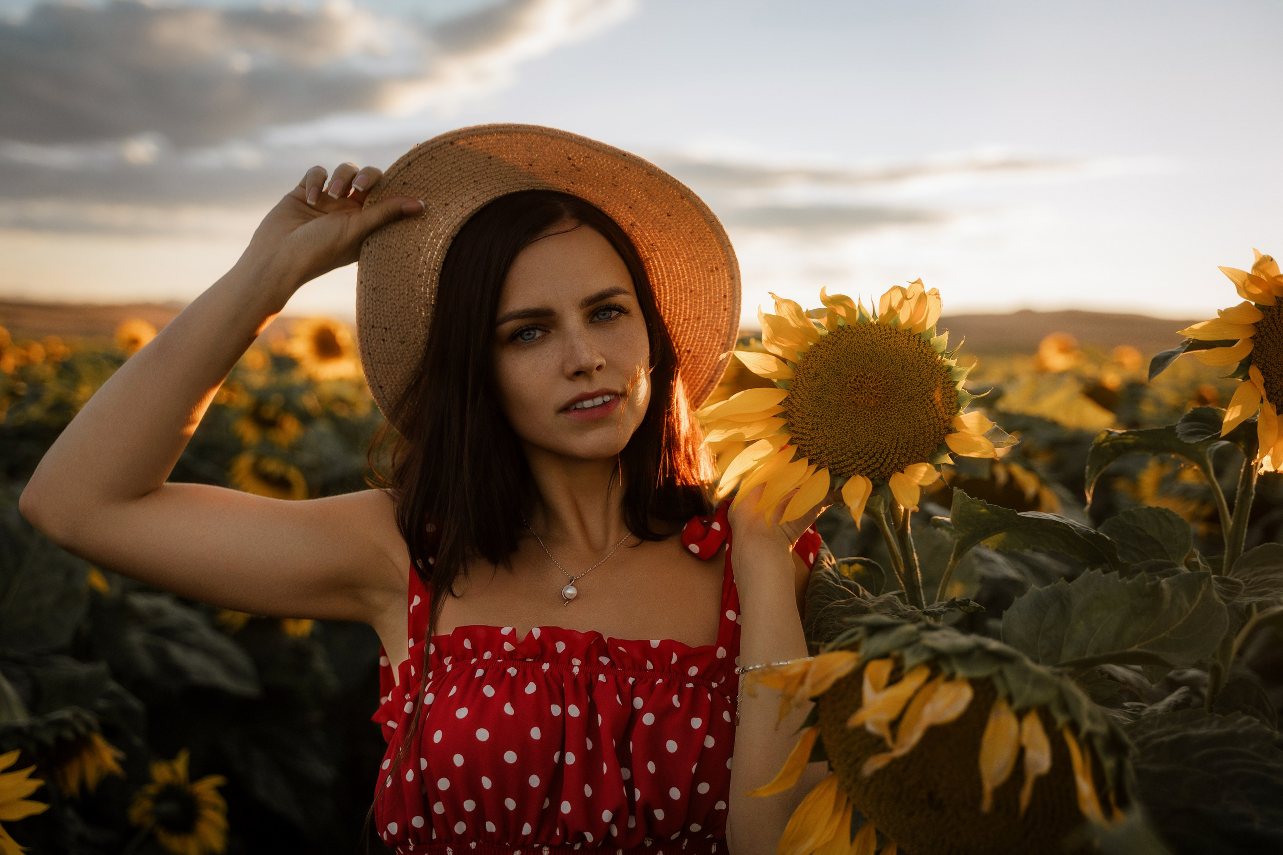 Elegant young woman in sunflower field at sunset, captured by Marbella portrait photographer