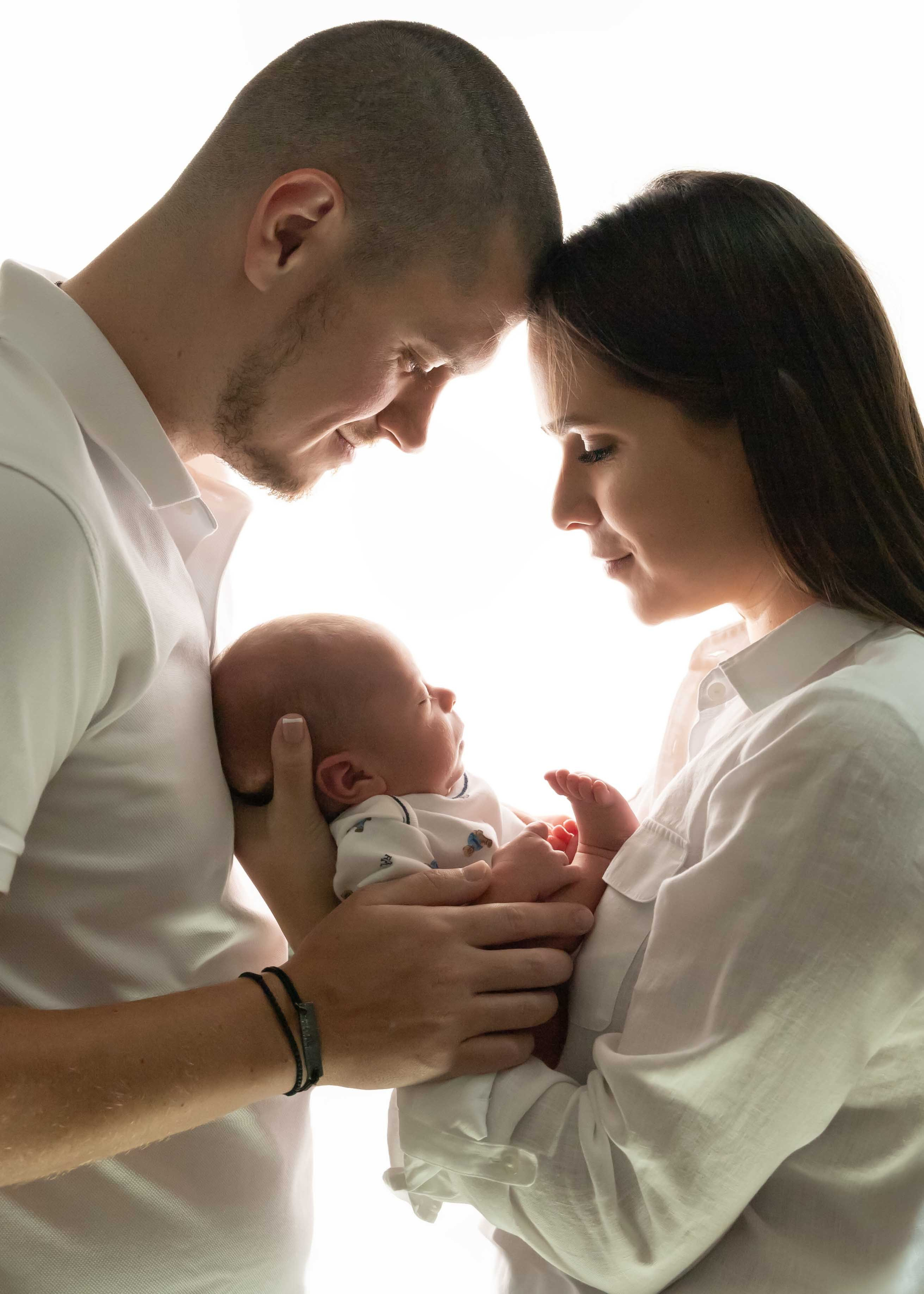 parents and newborn silhouette photo