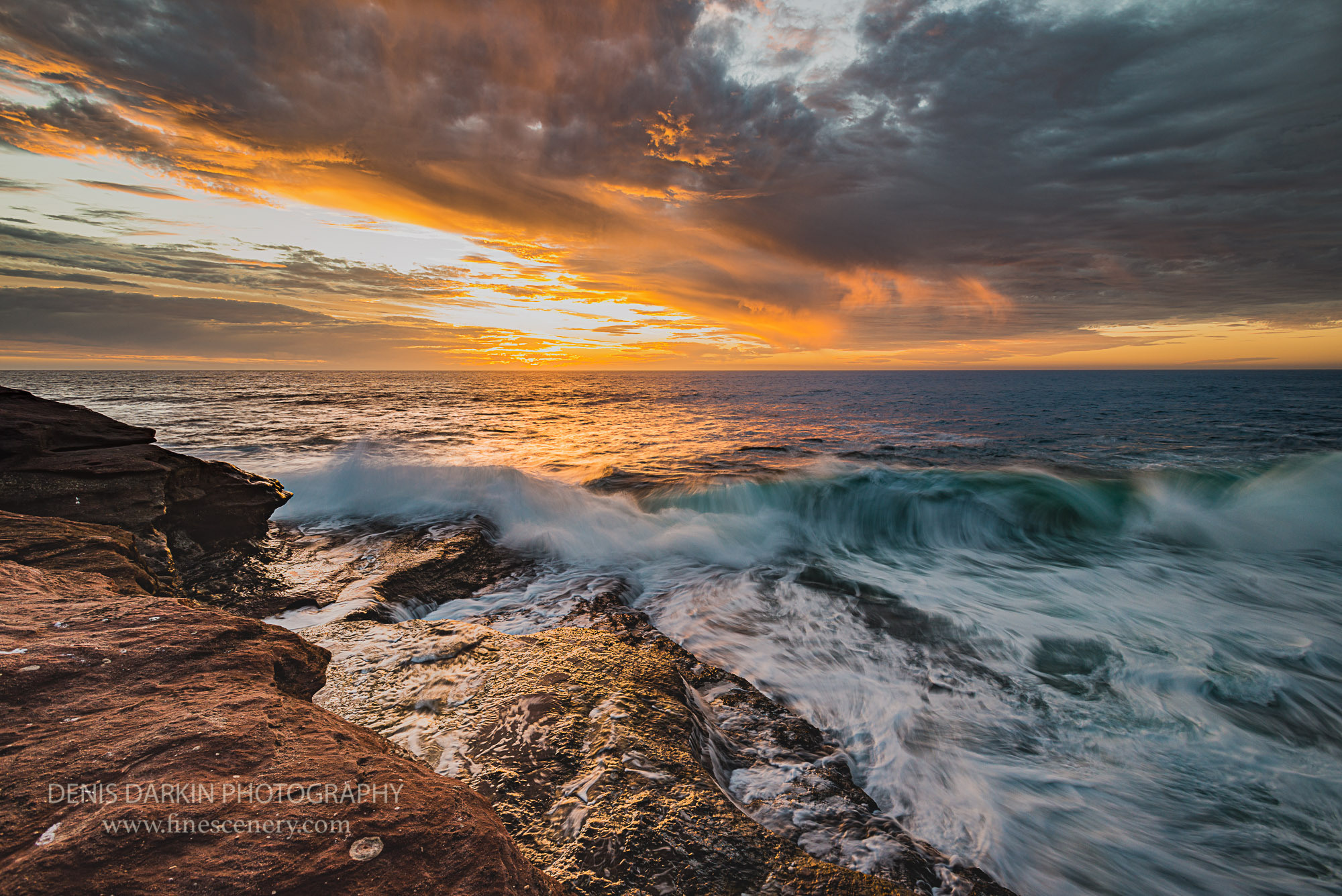 Passing storm clouds highlighted by sunset light at Red Bluff Beach. Indian ocean, Kalbarri, sunset, waves