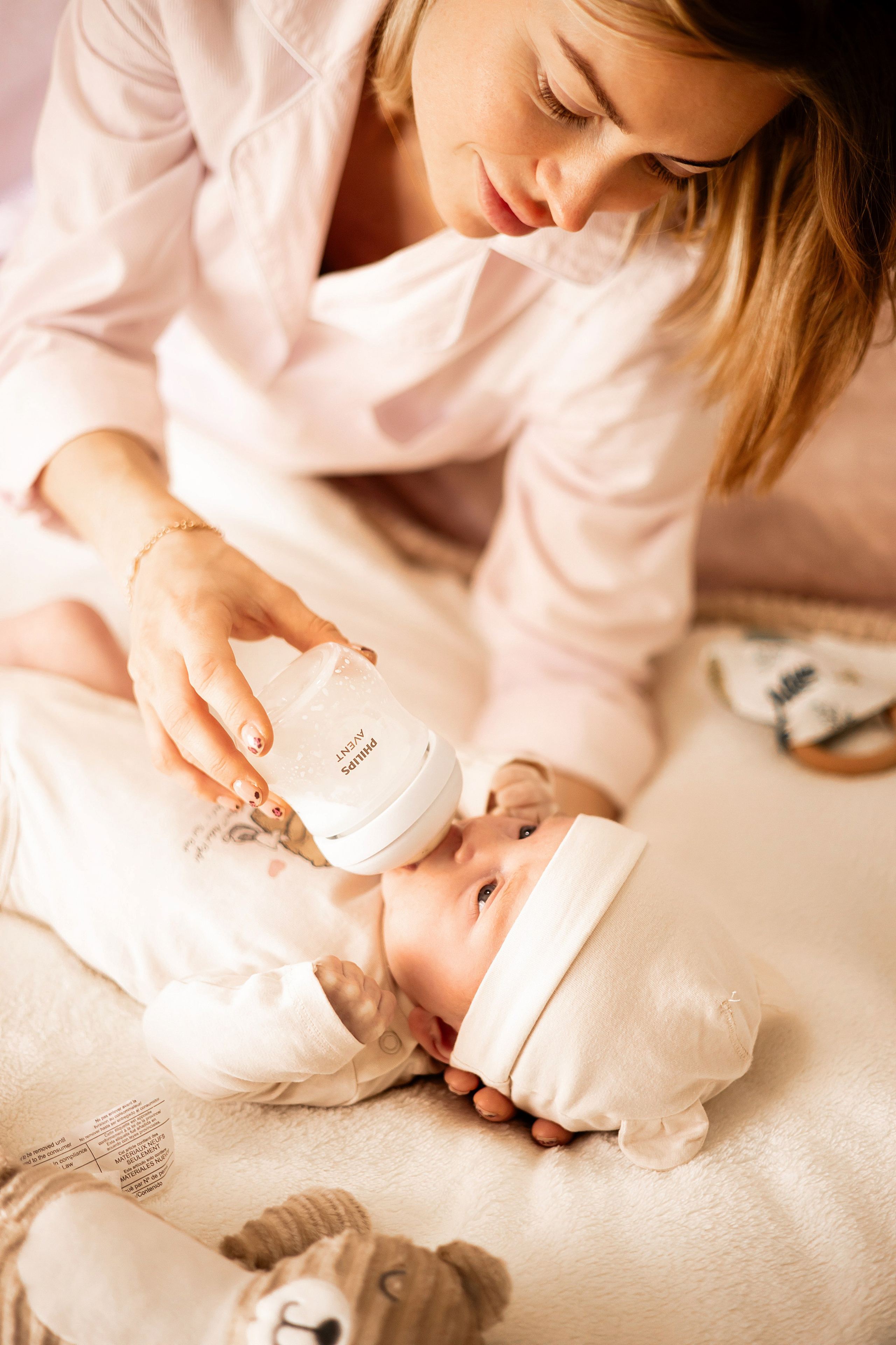 Family smiling at their newborn in the crib