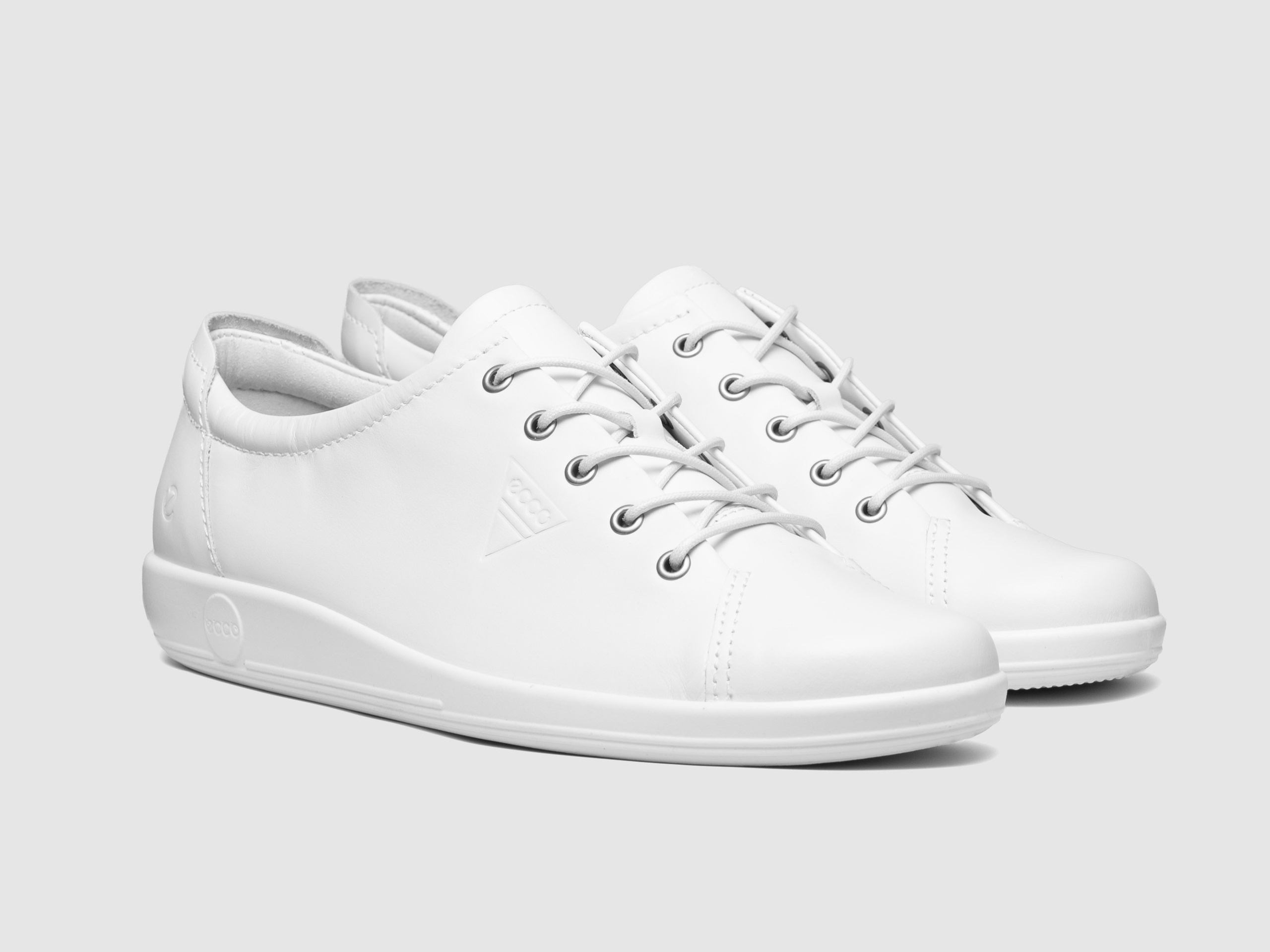 White leather sneakers white background minimalist footwear product photography