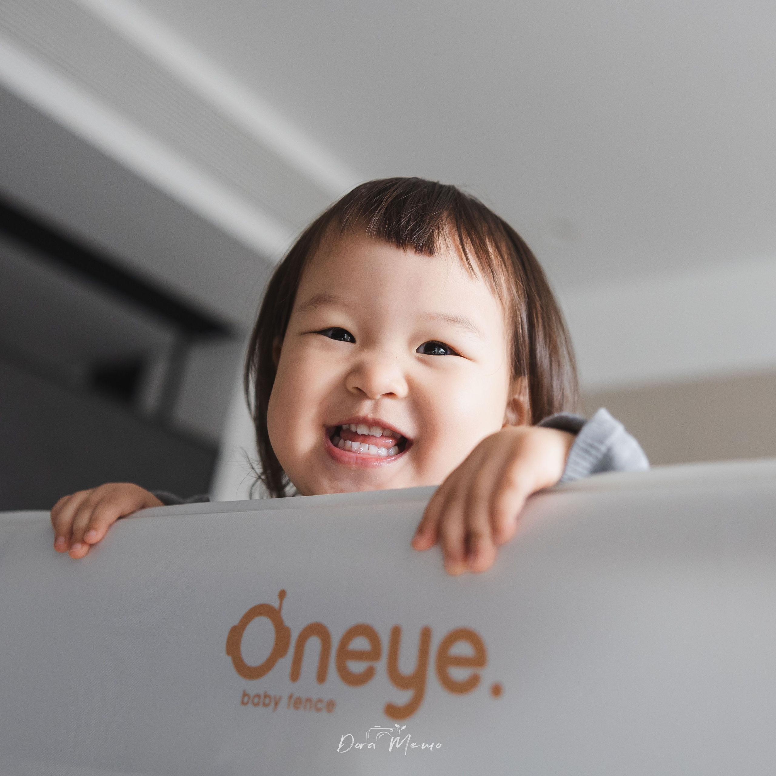 Close-up portrait of a happy toddler girl with expressive eyes and a gentle smile, natural child photography in Shanghai.