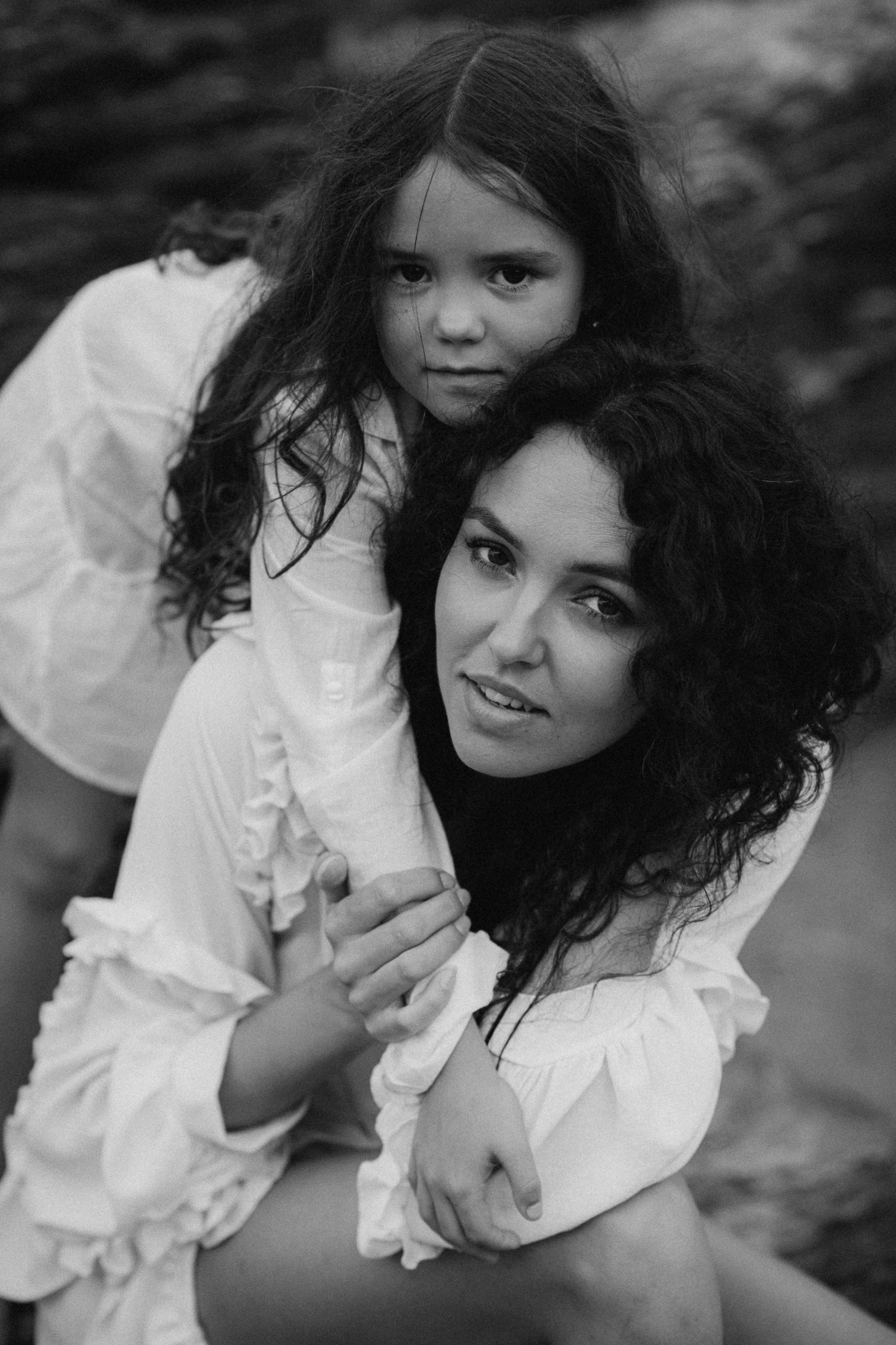 girl hugs her mother on the beach