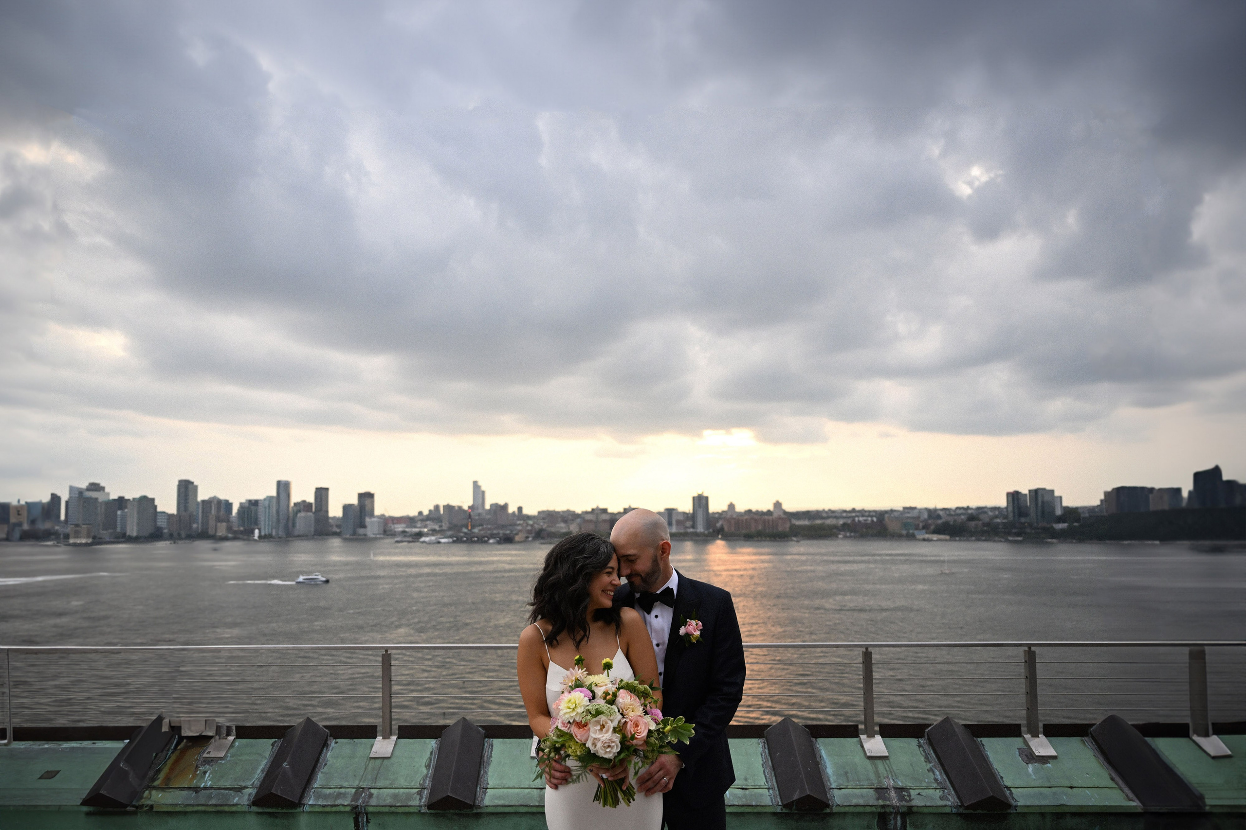 a bride and groom kissing on a boat
