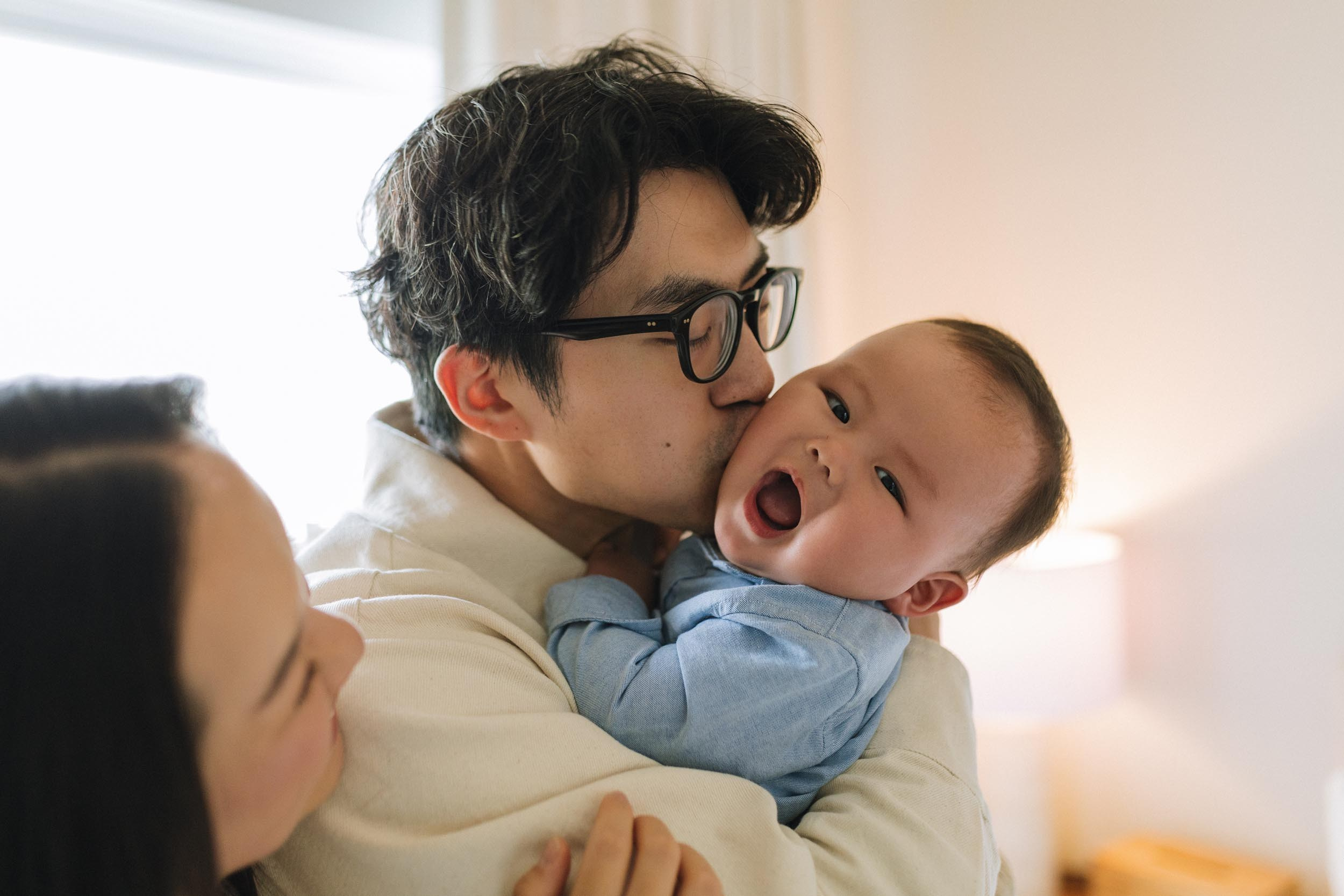 Father playing with his baby during an at-home family photo session