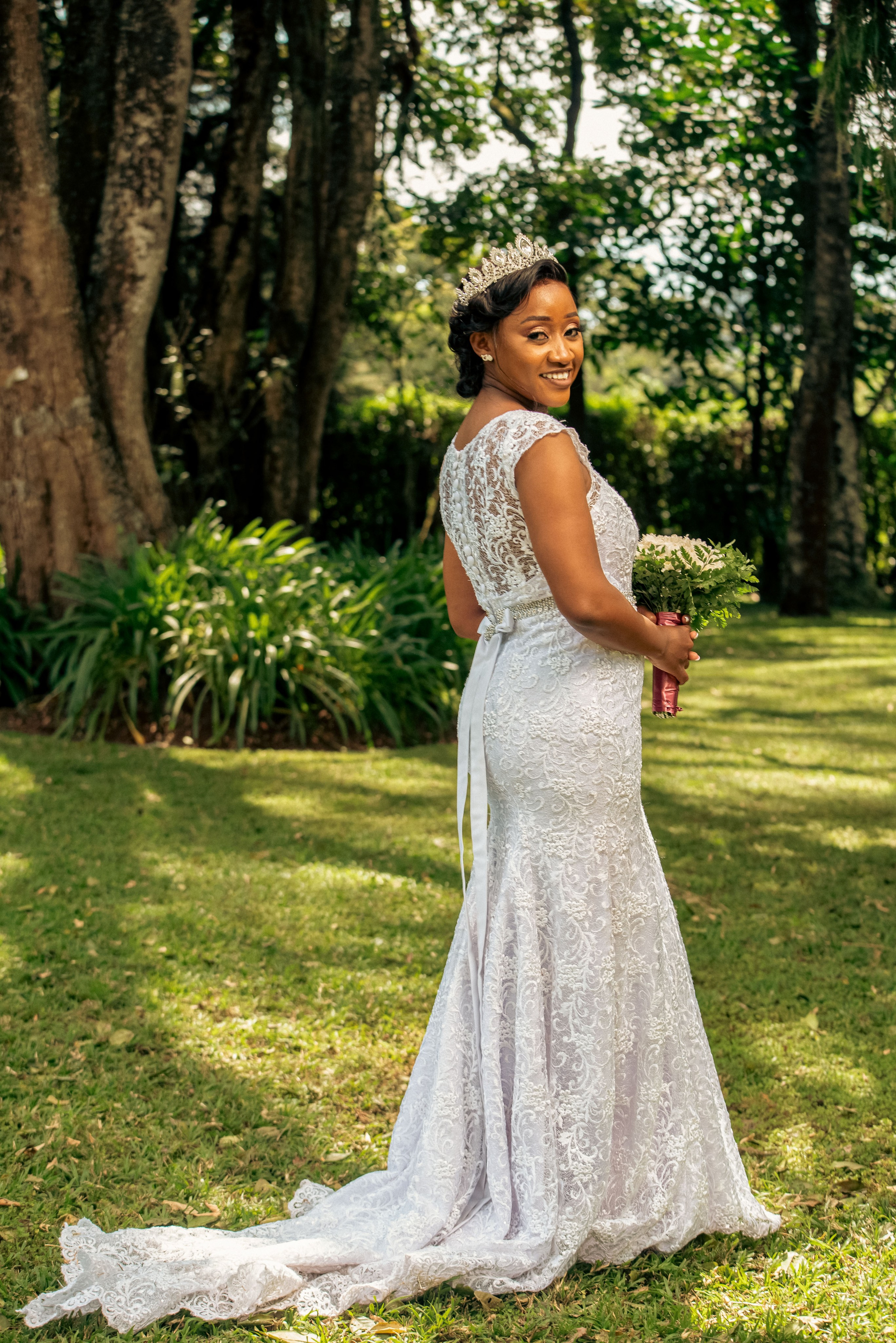 An elegant outdoor portrait of a bride in a lush green garden in Nairobi