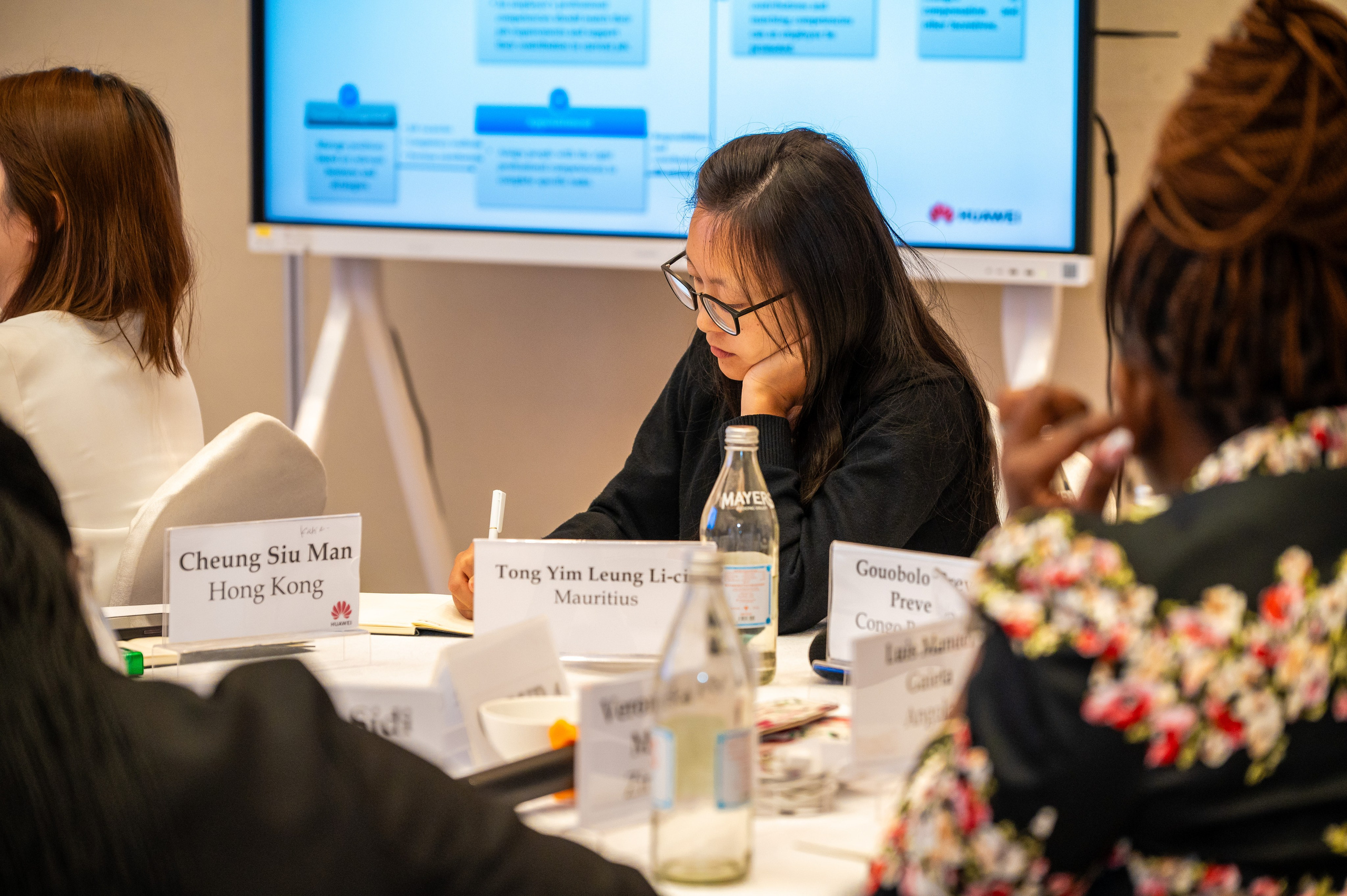 Focused attendee taking notes at a conference in Nairobi