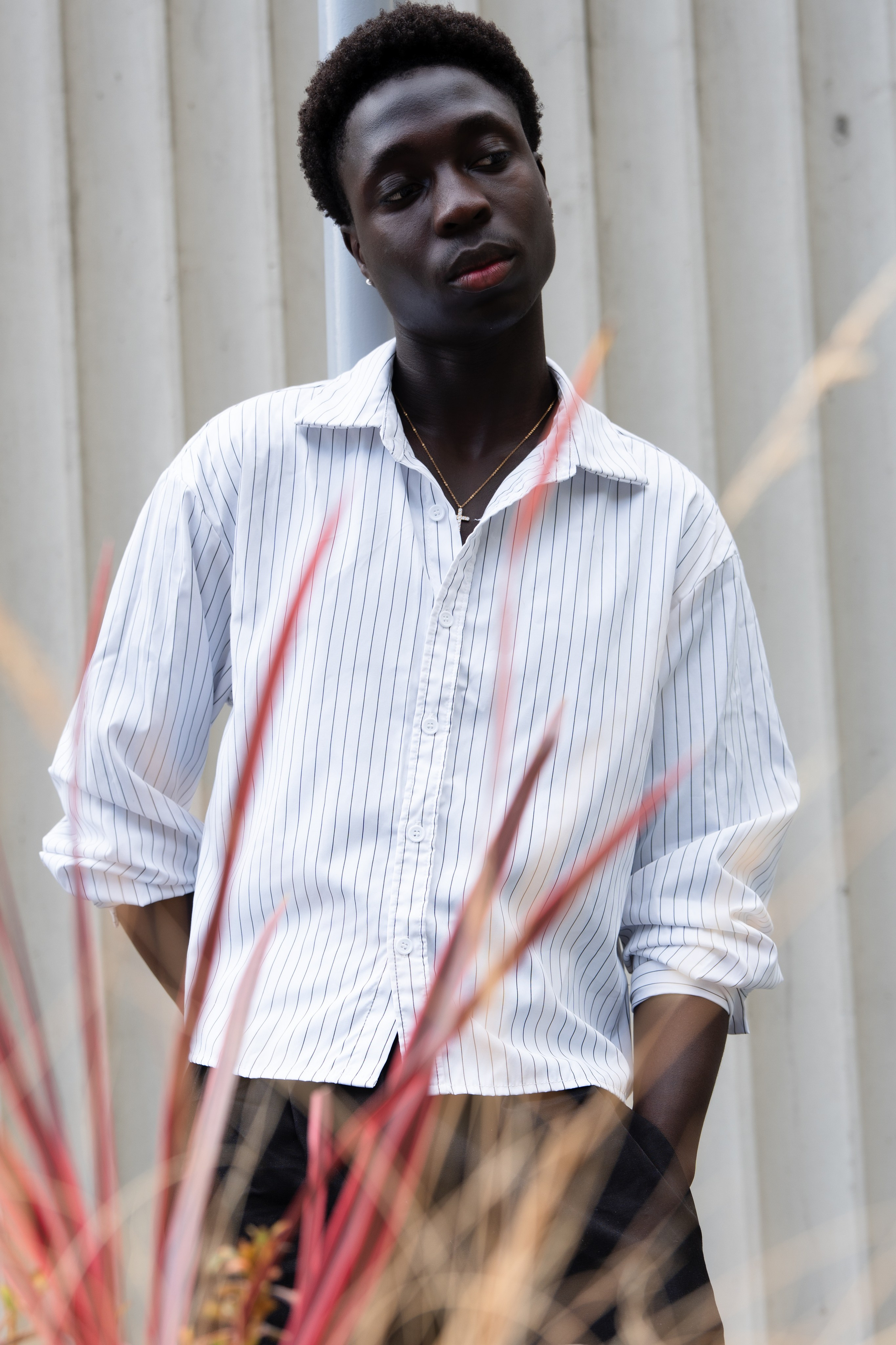 Male model in a striped shirt photographed in an urban setting