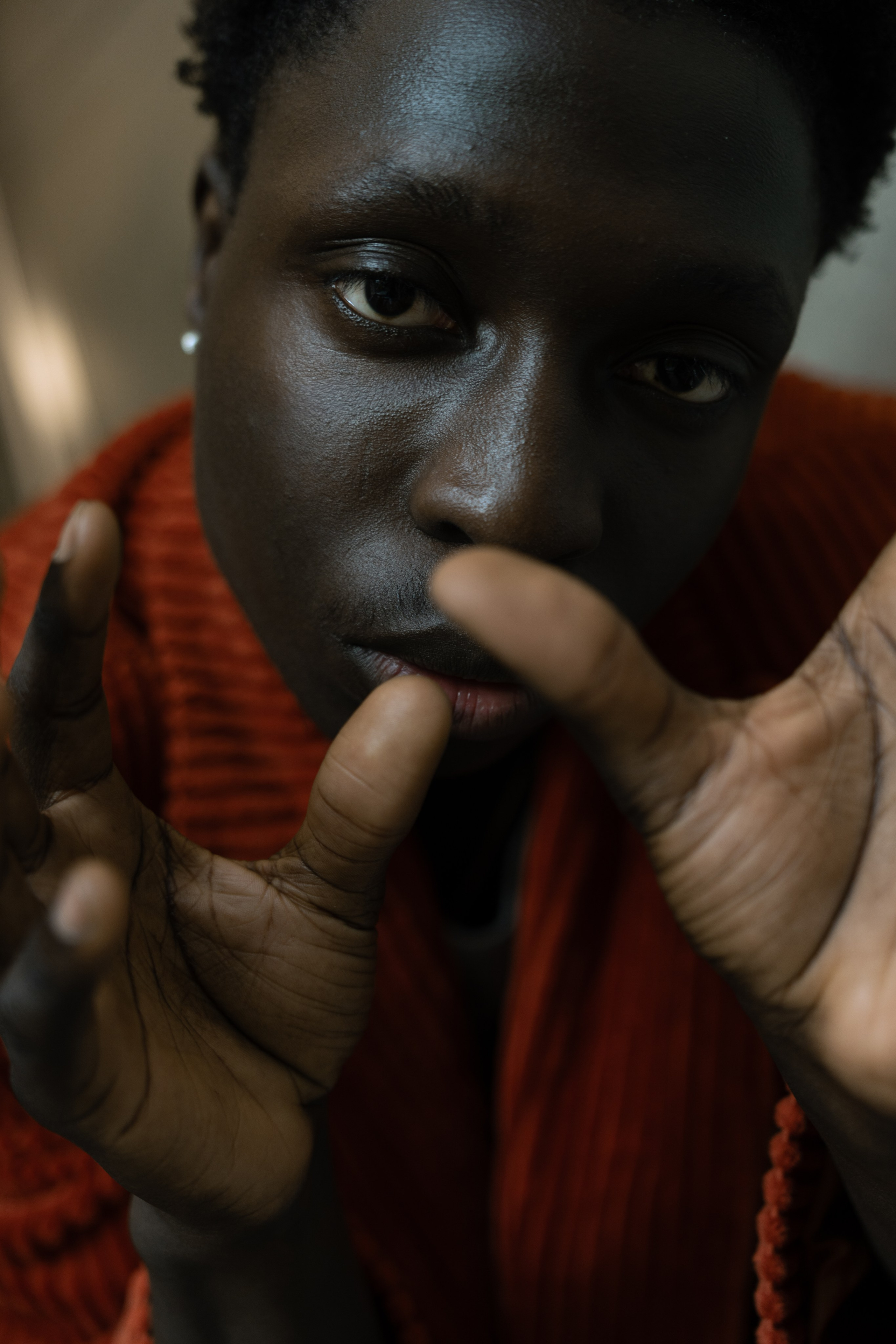 Creative close-up portrait of a male model wearing a red textured top