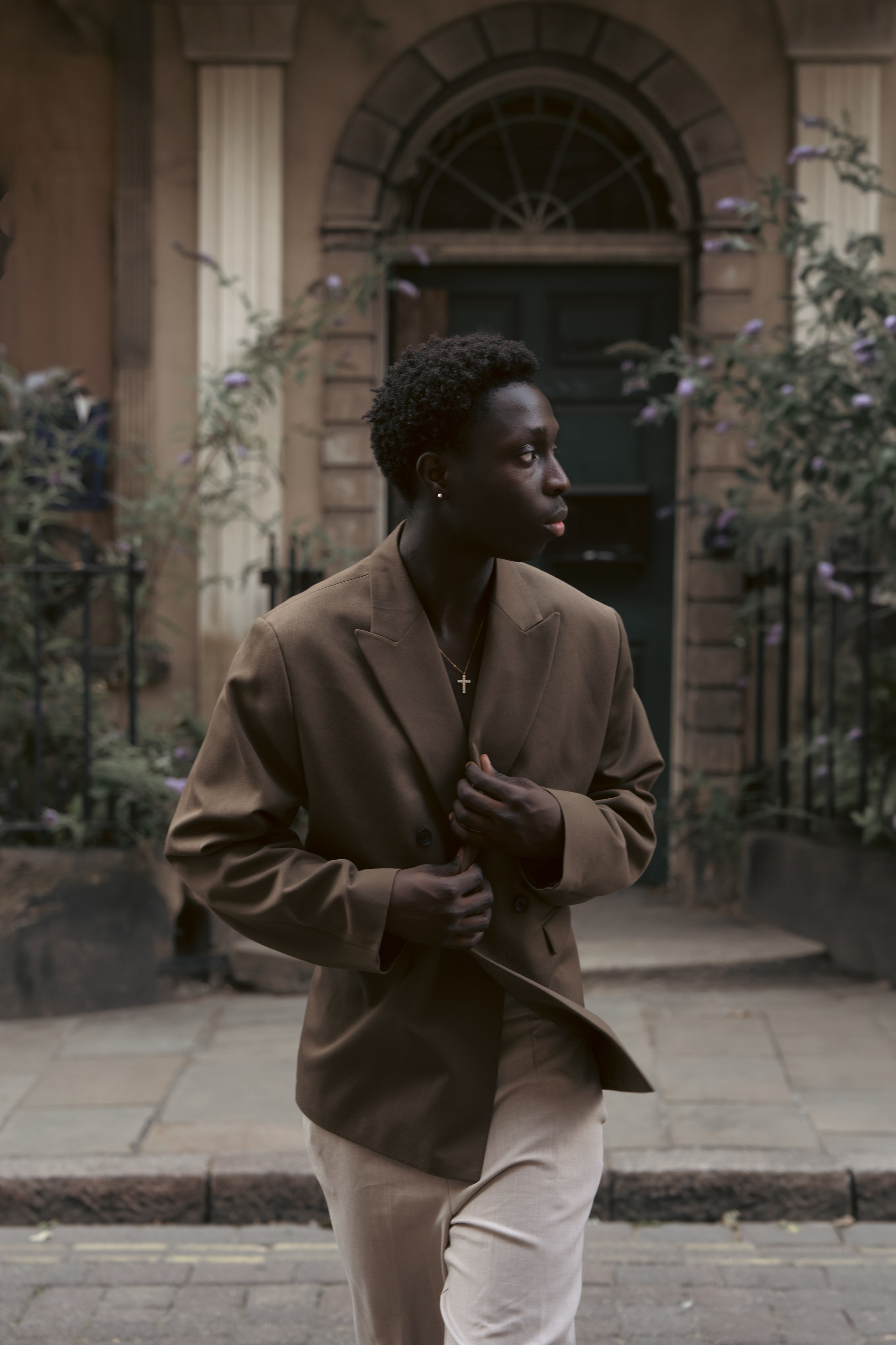 Male model in a brown suit photographed on a city street