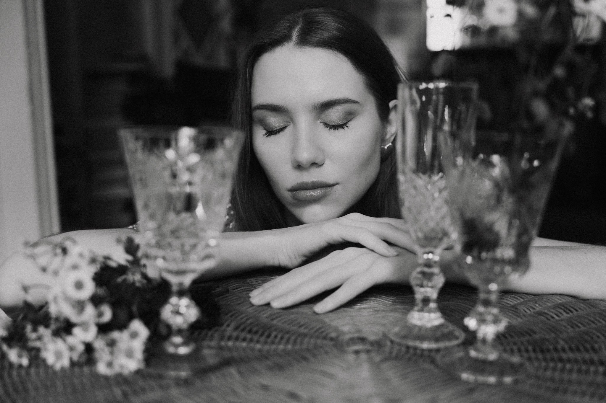 Creative black and white female portrait with vintage glassware