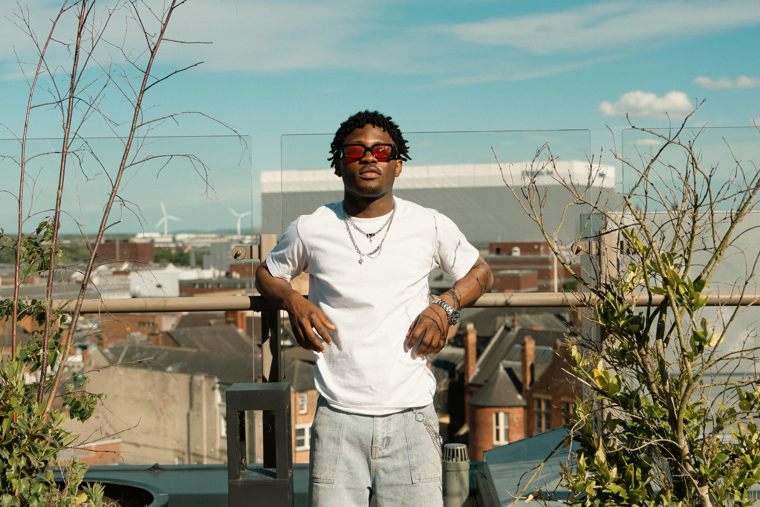 Male fashion model photographed on a rooftop with an urban skyline