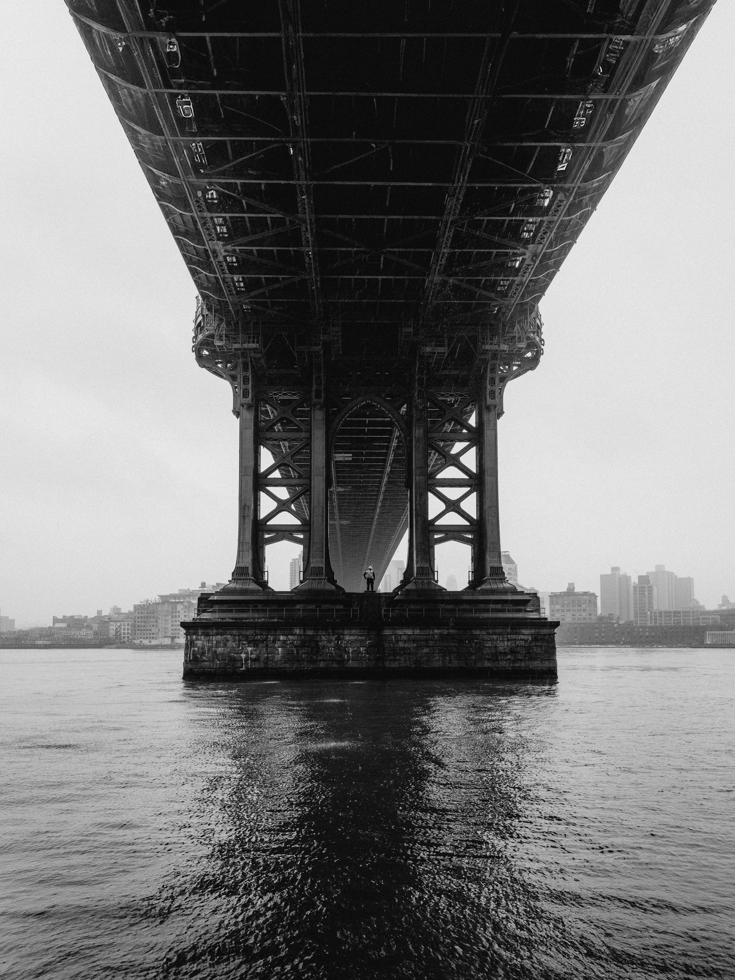 A worker standing under the bridge in New York City 