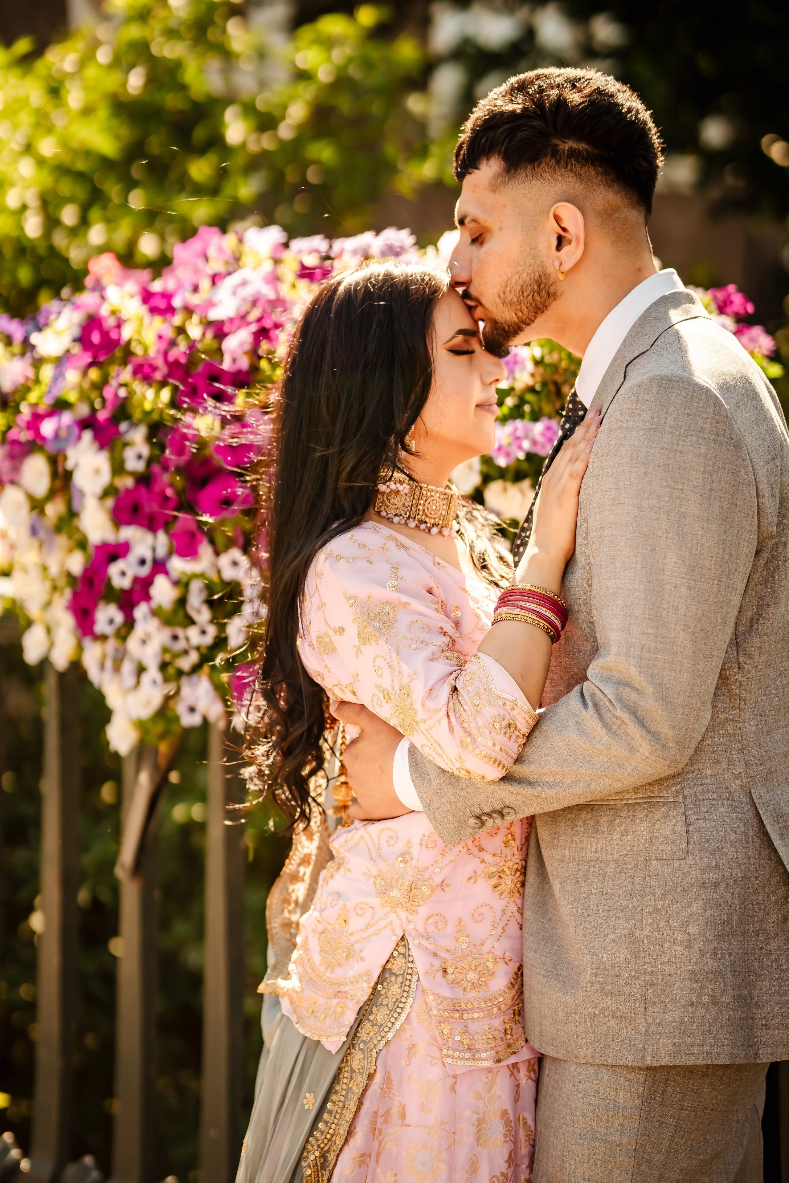 a man kissing the forehead of his bride