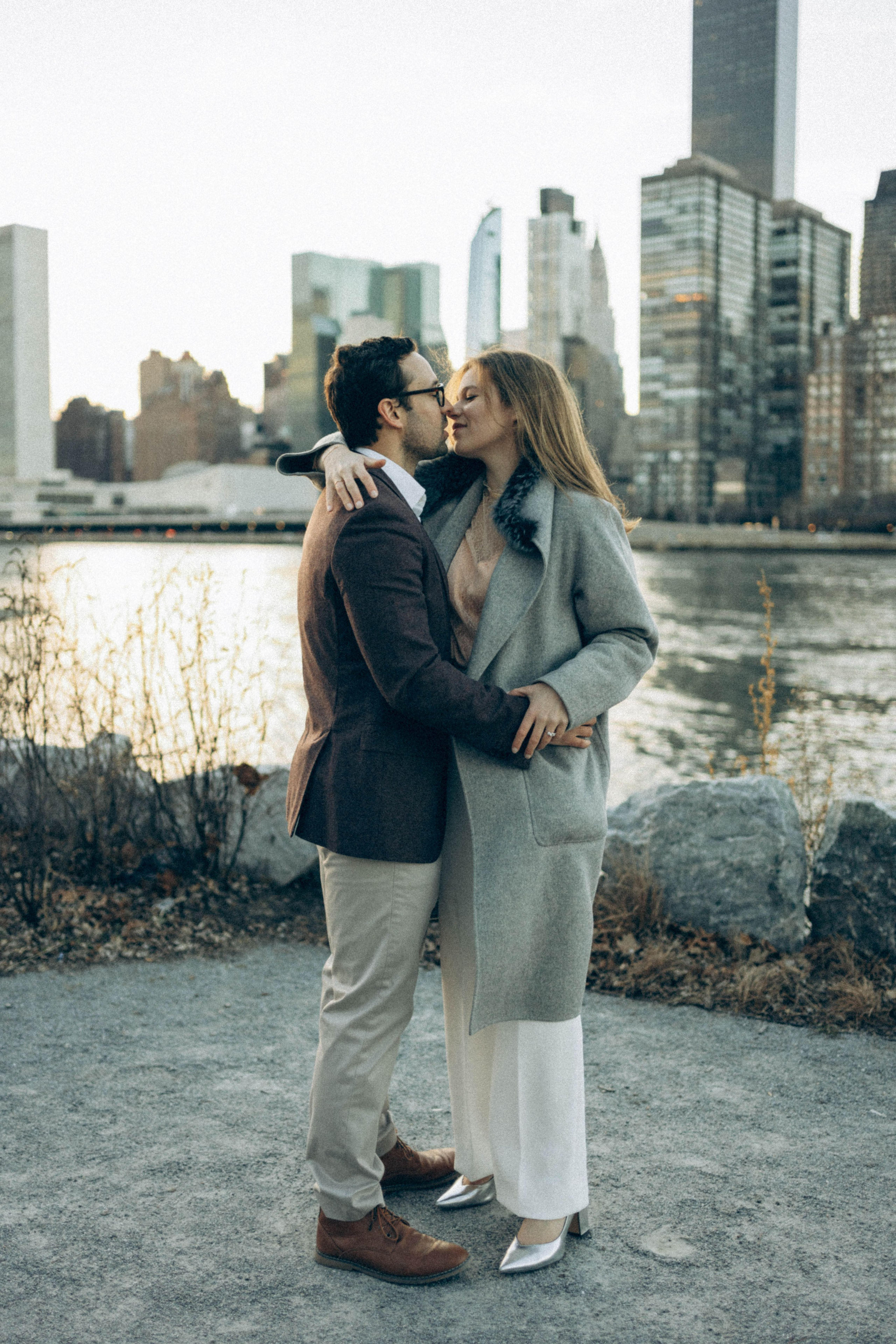 Emotional proposal moment in Central Park meadow.