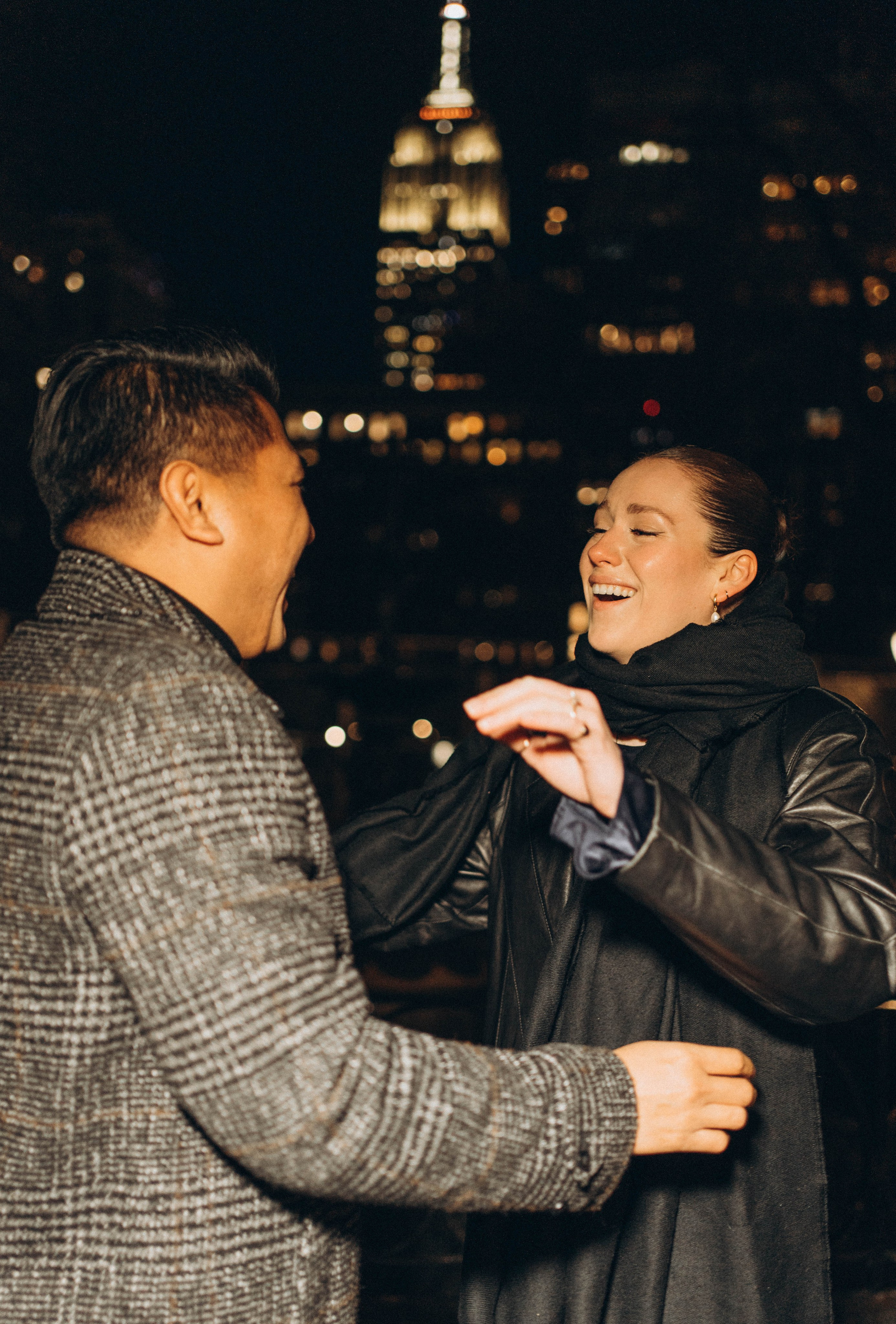 Proposal near Manhattan Bridge park with sunset glow.