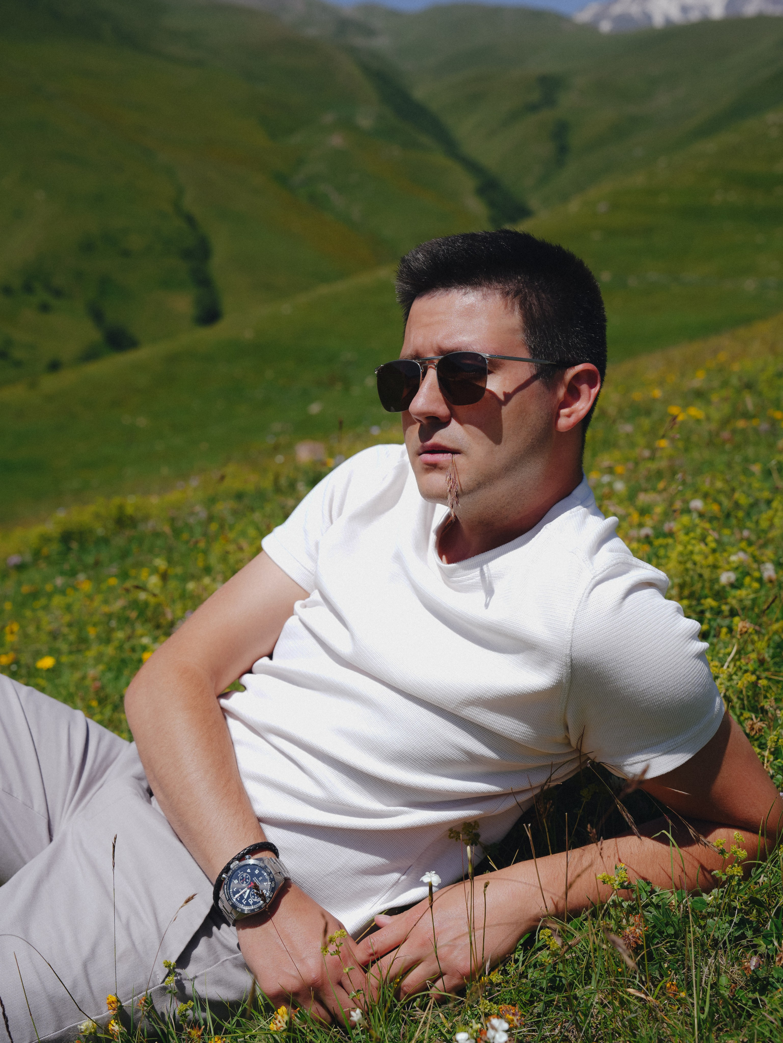 Man relaxing on grass in Kazbegi mountains