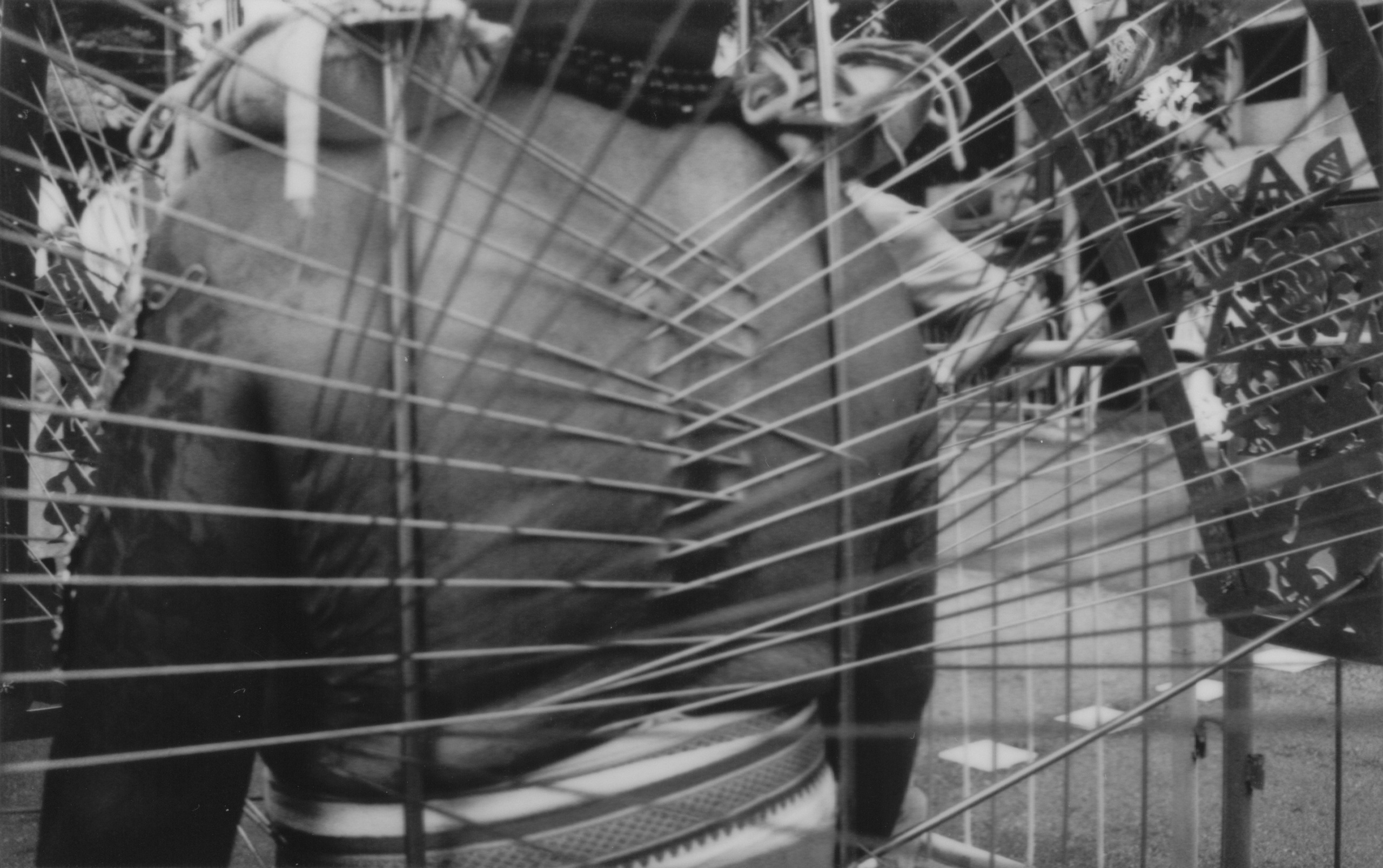 An evocative black-and-white photograph capturing a Thaipusam devotee’s back, adorned with hooks and rods in a sacred ritual during a cultural event in Singapore. This striking image demonstrates the photographer’s mastery in reportage and event photography, blending storytelling with meticulous attention to detail. Ideal for clients seeking professional documentation of cultural, corporate, or community events with a journalistic edge.