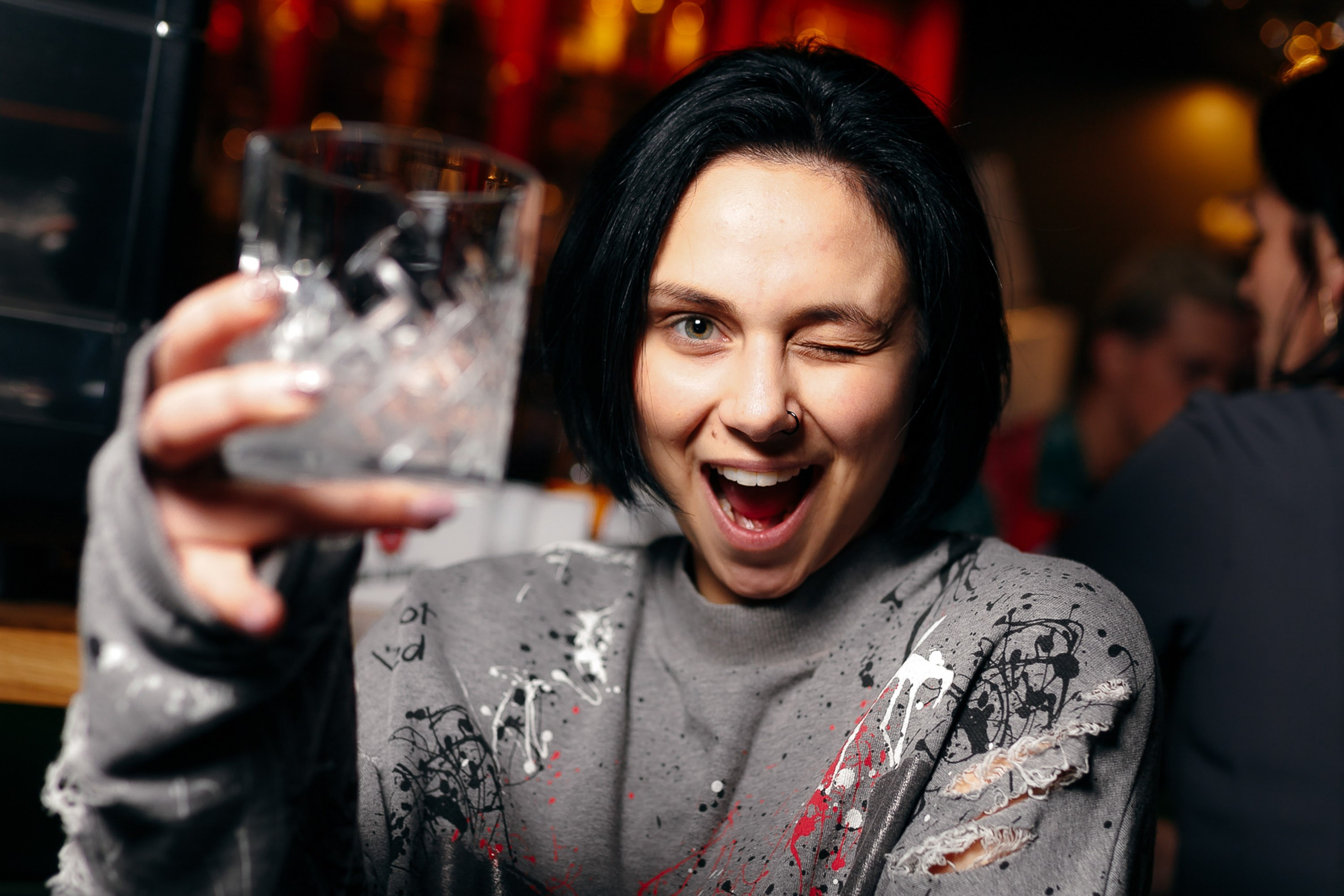 Man holding drink and laughing at party