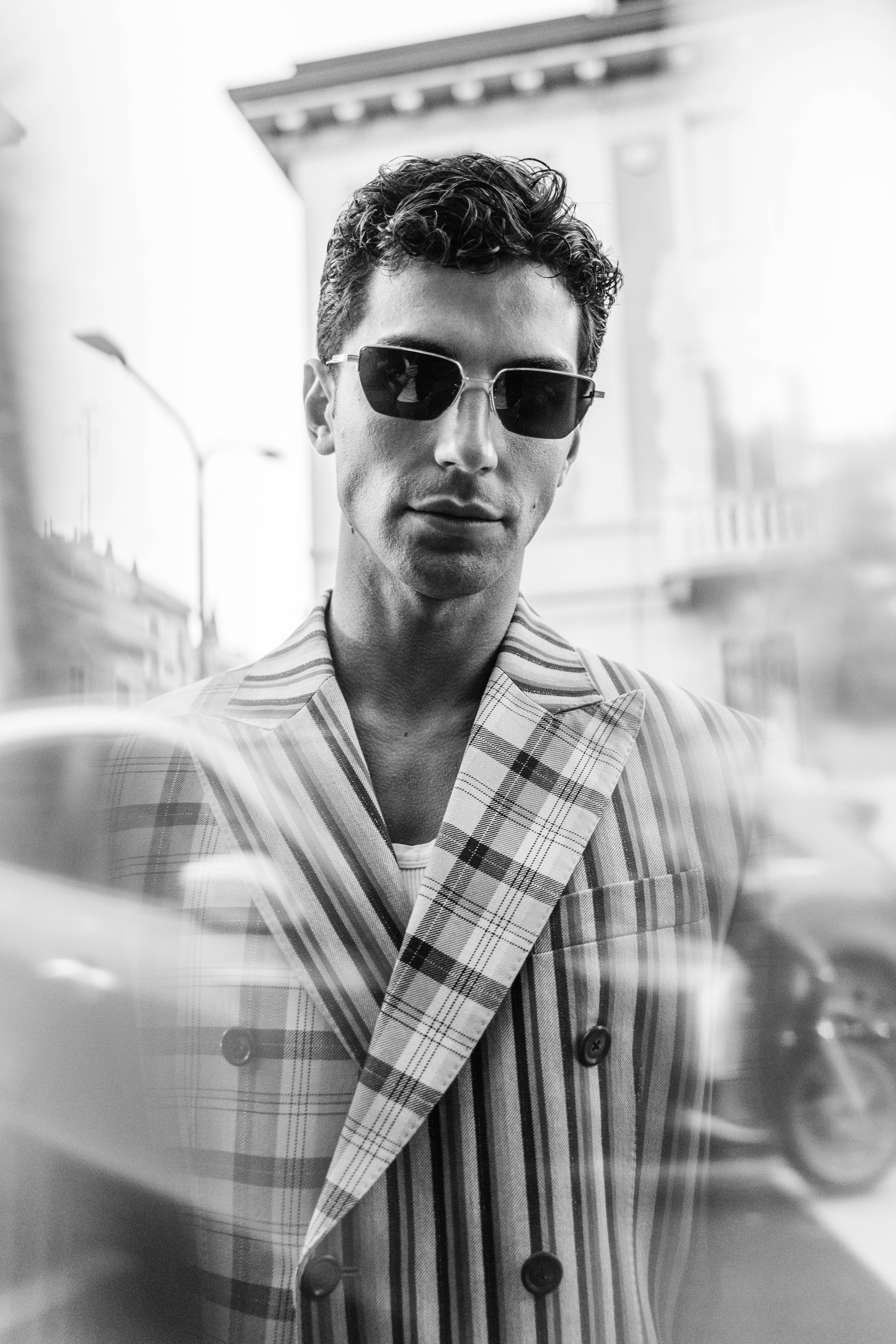 Monochrome portrait of a man in striped blazer and sunglasses