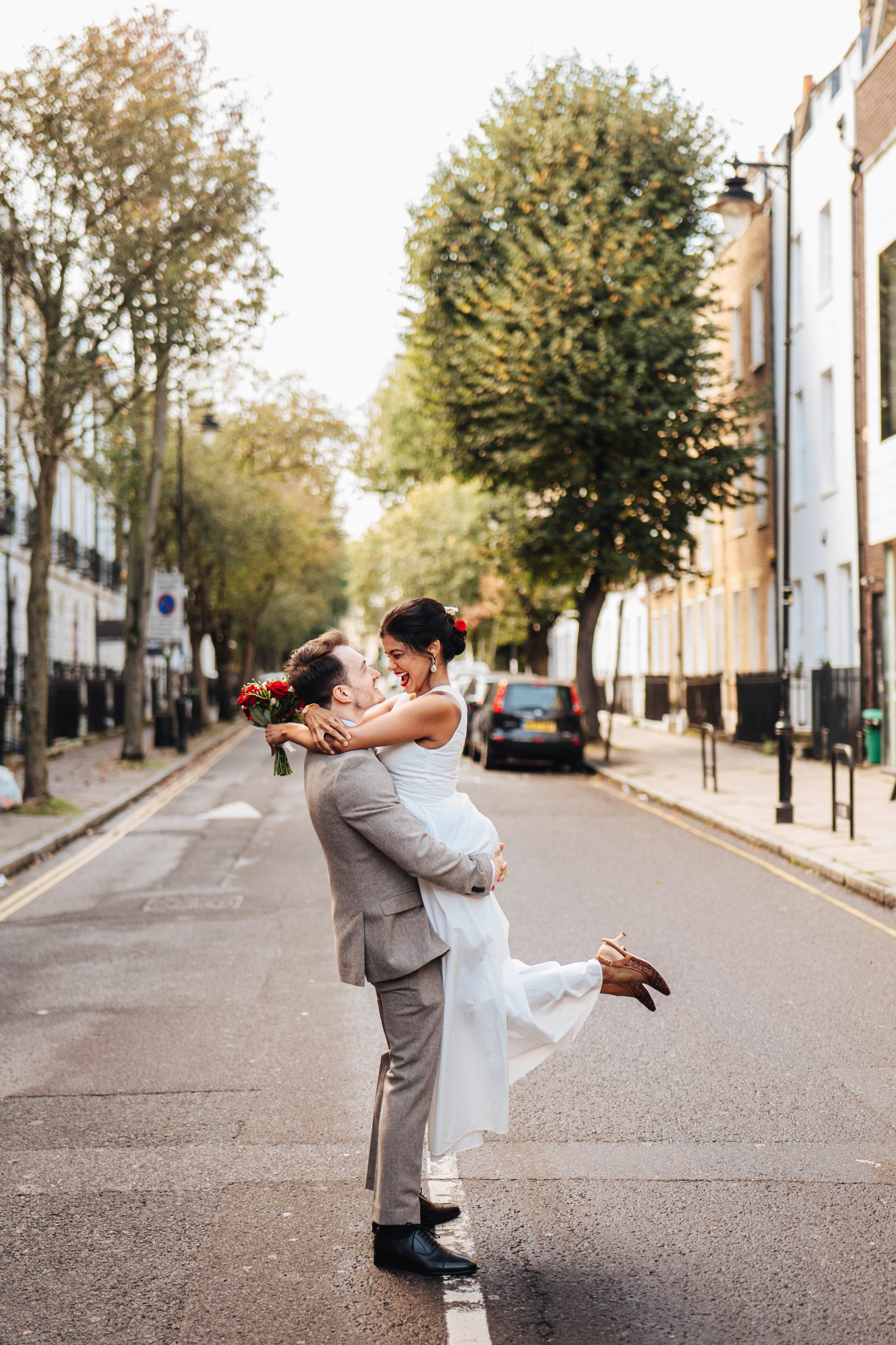 Wedding couple on the road crossing in Islington near Islington town hall