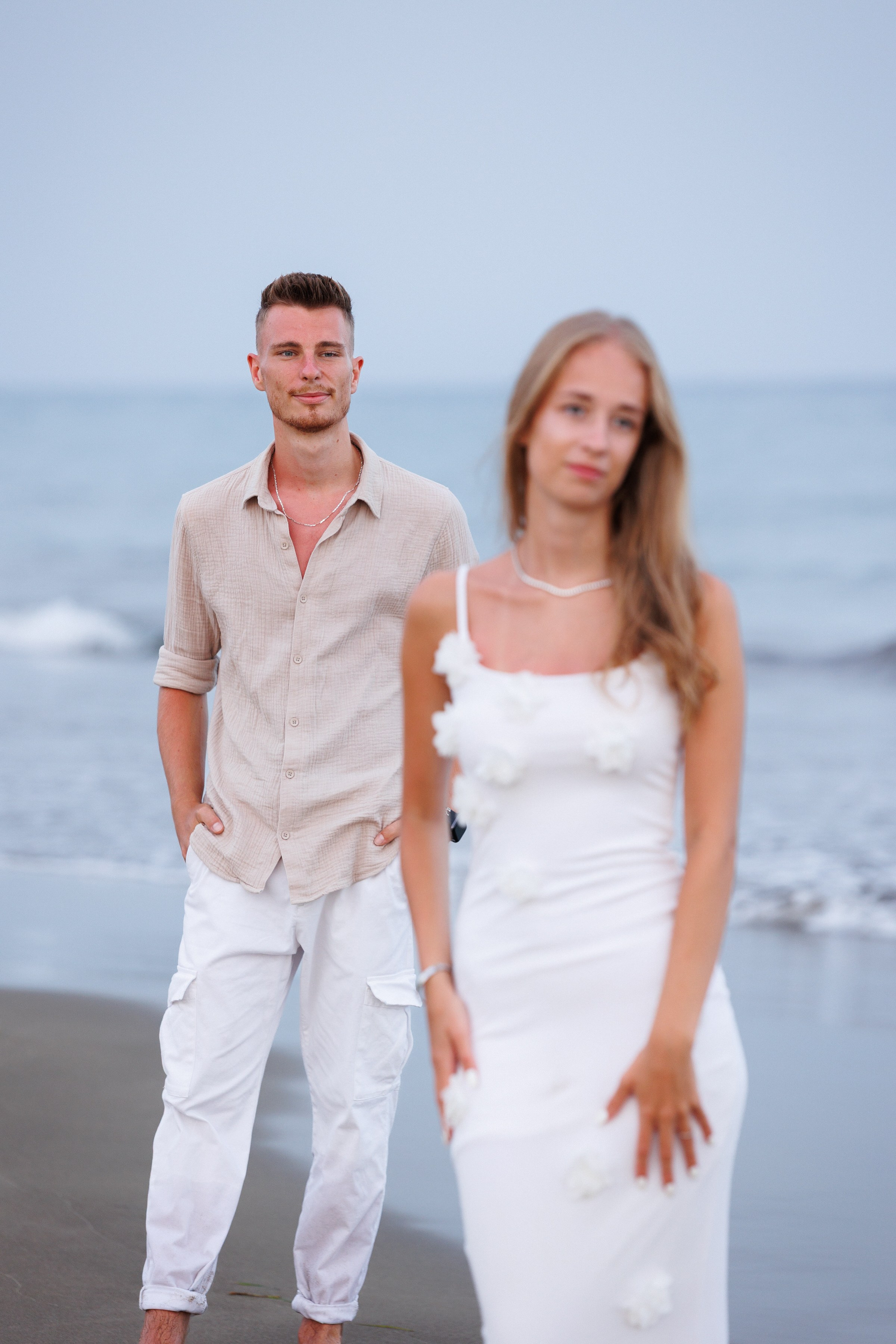 Soft light on dune grasses and the distant lighthouse — peaceful nature detail from a beach session by local freelancer Slavik Robtsenkov.