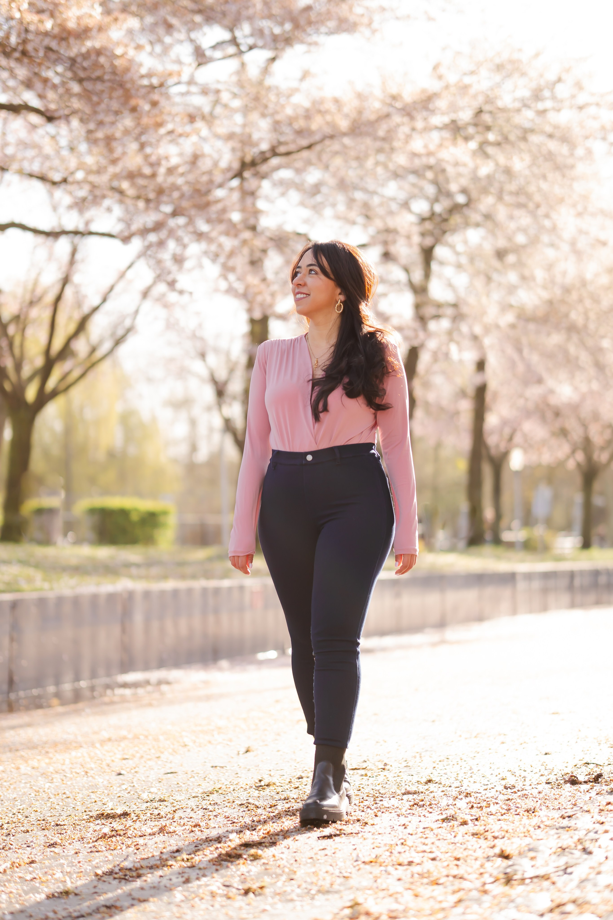girl walking in a cherry blossoms garden in Netherlands