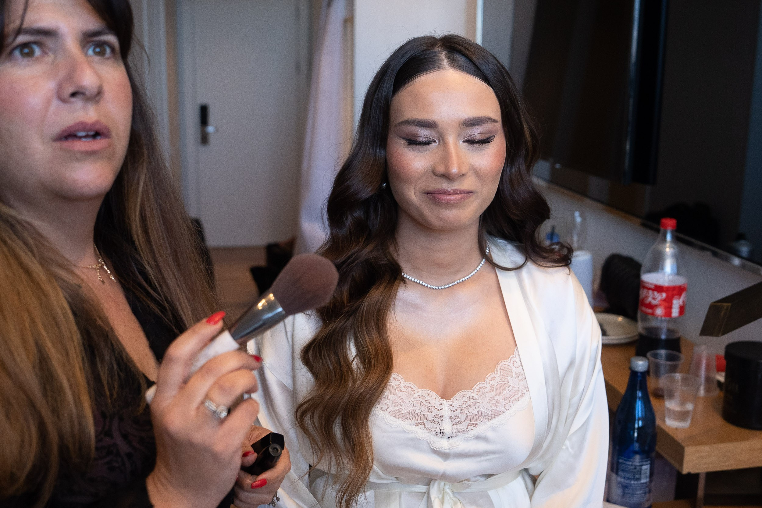 Bride Lin having her wedding makeup done by a professional artist during morning preparations in Netanya, Israel