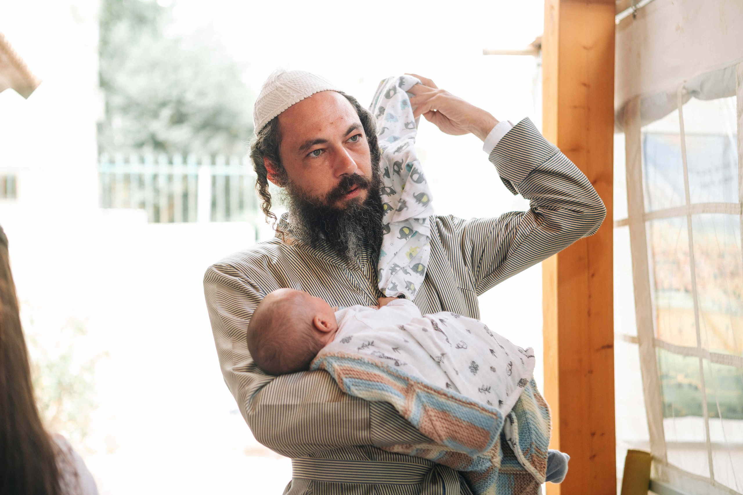 BRITH MILA IN THE SMALL SYNAGOGUE. PHOTOGRAPHER IN ISRAEL